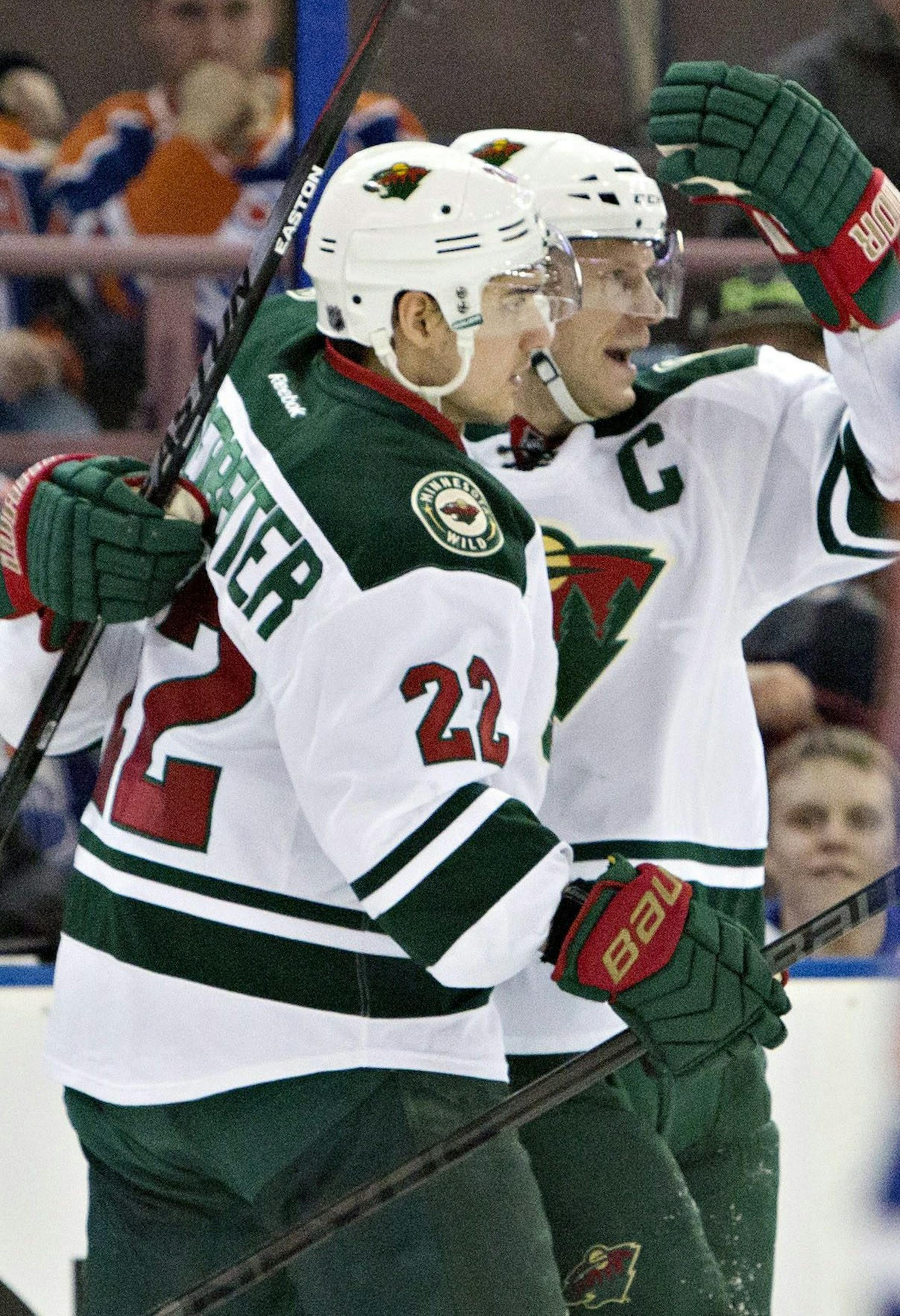 Minnesota Wild's Nino Niederreiter (22) and Mikko Koivu (9) celebrate a goal against the Edmonton Oilers during the first period of an NHL hockey game Friday, Feb. 20, 2015, in Edmonton, Alberta. (AP Photo/The Canadian Press, Jason Franson)