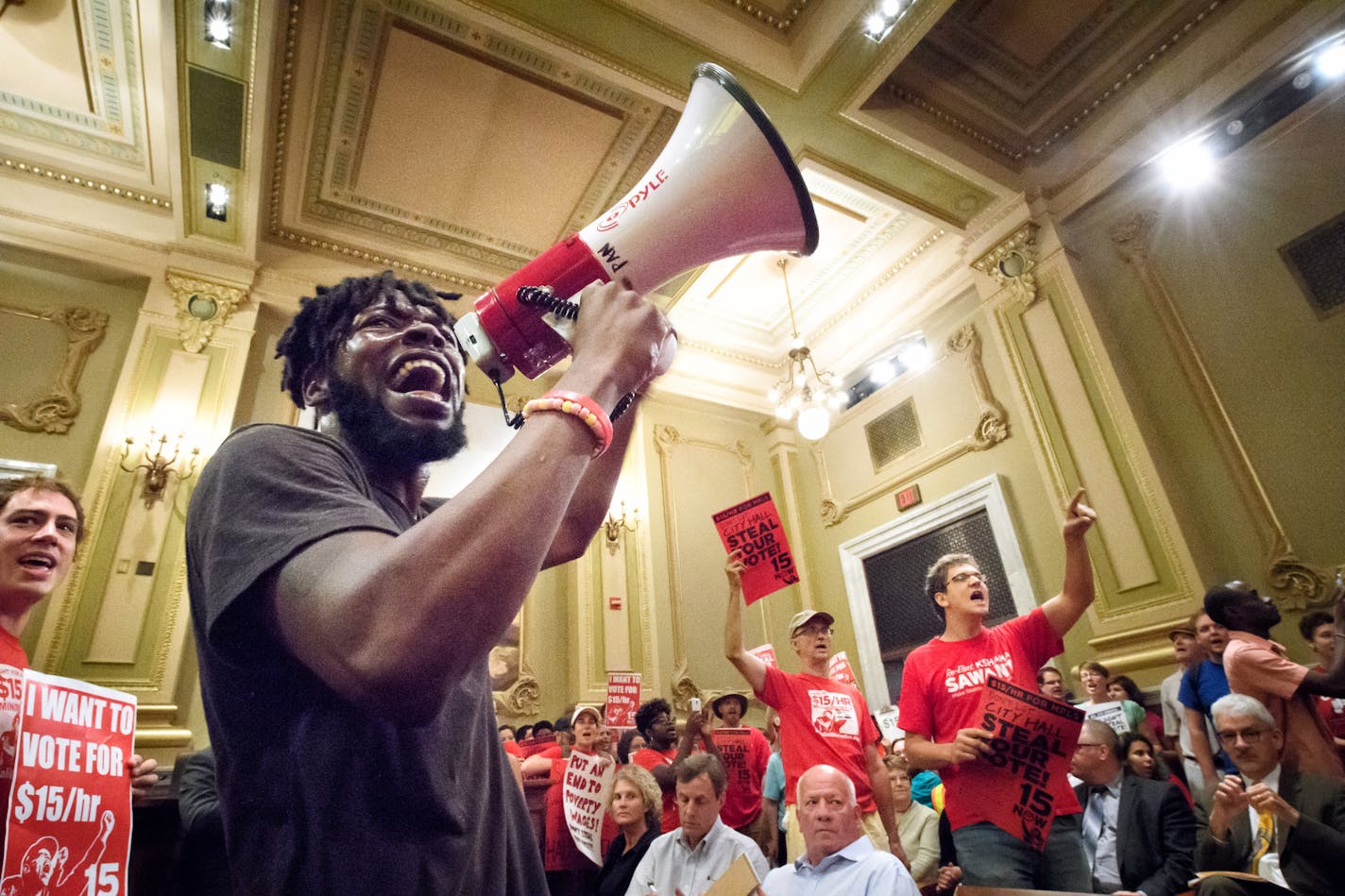 Rod Adams, economic justice organizer for Neighborhoods Organizing for Change, led the group inside the City Council Chambers. ] GLEN STUBBE * gstubbe@startribune.com Wednesday, August 3, 2016 Members of 15 Now, NOC, CTUL and other groups trying to get a $15 minimum wage on the Minneapolis ballot this November gathered outside City Hall and marched together as a group into council chambers to press their demands.