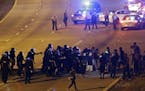 Police confront protesters blocking I-277 during a third night of unrest following Tuesday's police shooting of Keith Lamont Scott in Charlotte, N.C.,