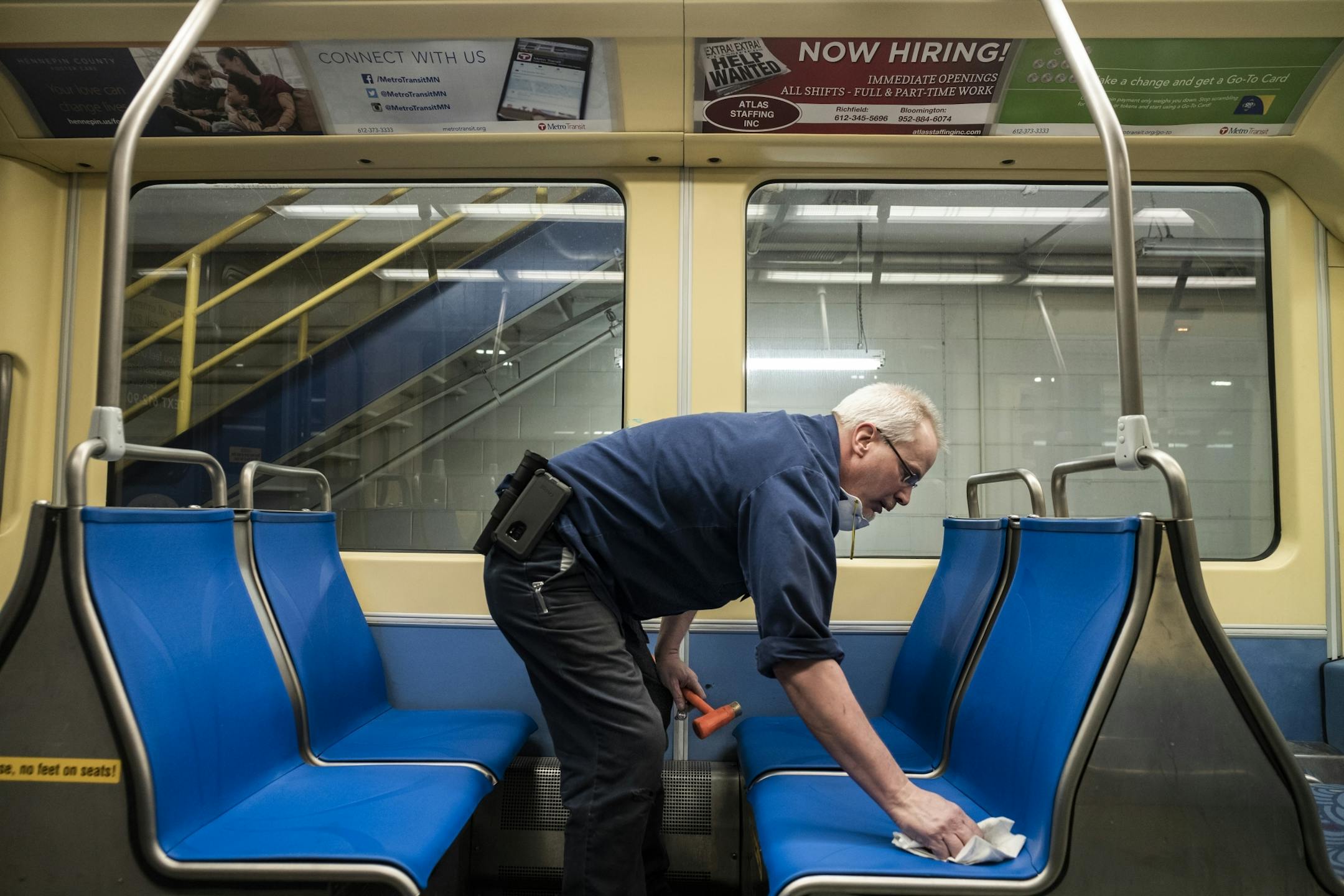 Electromechanical technician Timothy Malmstedt disassembled old cloth seats and installed new plastic seats as part of a test program to try seats that are easier to maintain.