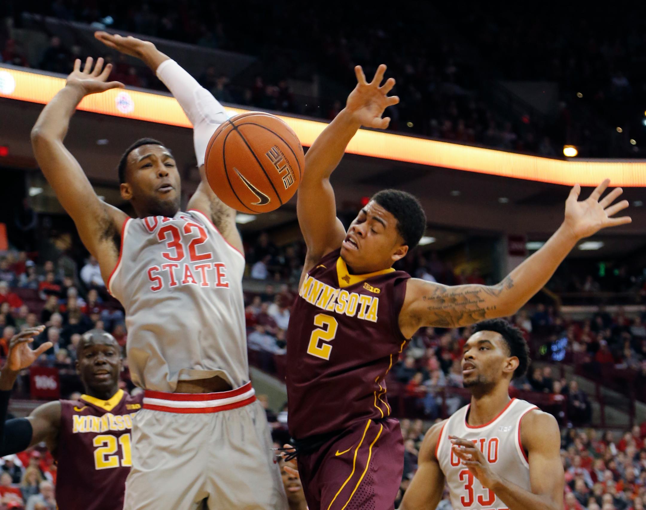 Minnesota's Nate Mason, right, loses control of the ball while driving to the basket against Ohio State's Trevor Thompson during the first half of an NCAA college basketball game, Wednesday, Dec. 30, 2015, in Columbus, Ohio. (AP Photo/Jay LaPrete)