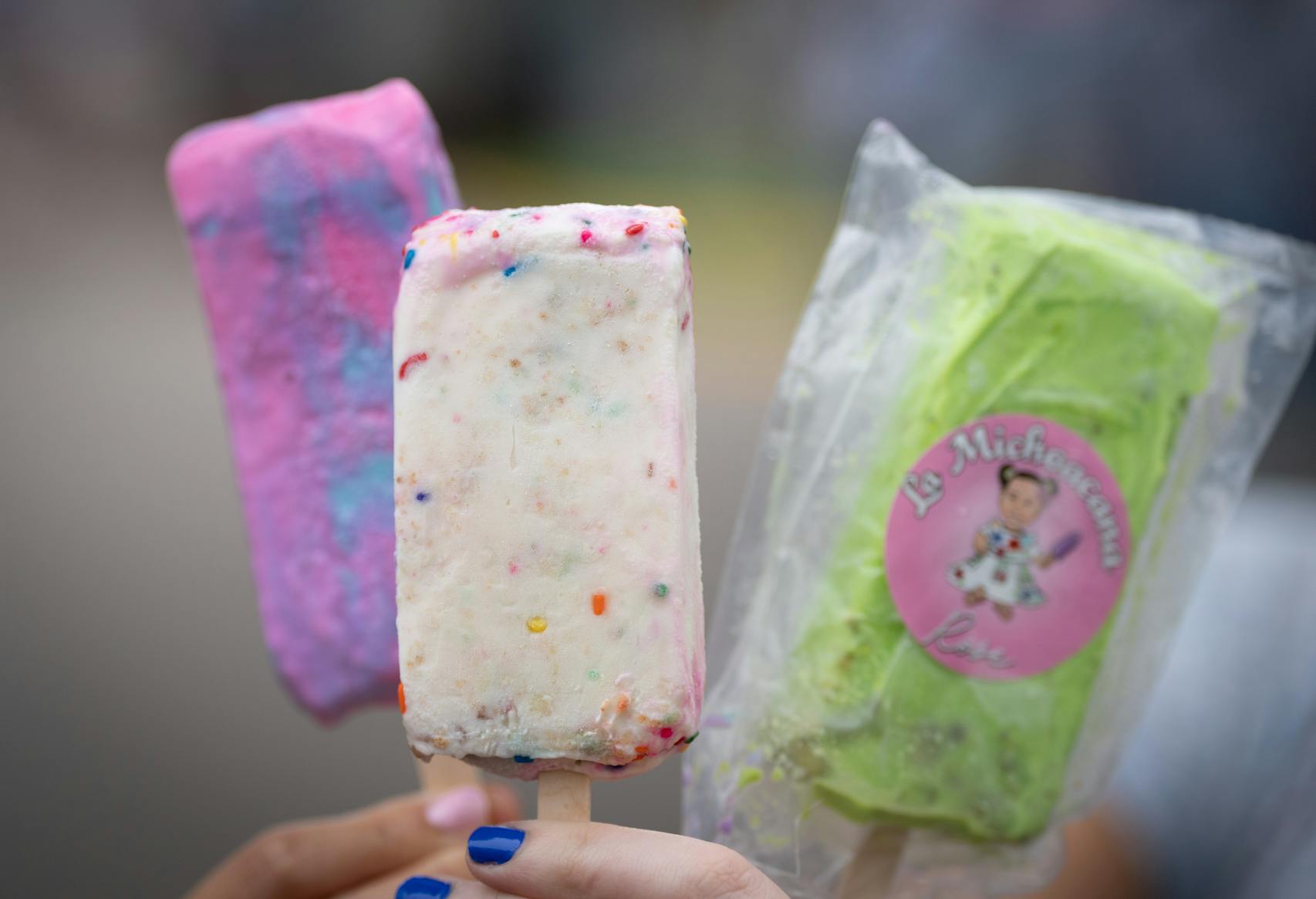 Birthday Cake Paleta from the Hamline Church Dining Hall. Also pictured is the bubblegum, at left, and pistachio, right. New foods at the Minnesota State Fair photographed on Thursday, Aug. 25, 2022 in Falcon Heights, Minn. ] RENEE JONES SCHNEIDER • renee.jones@startribune.com