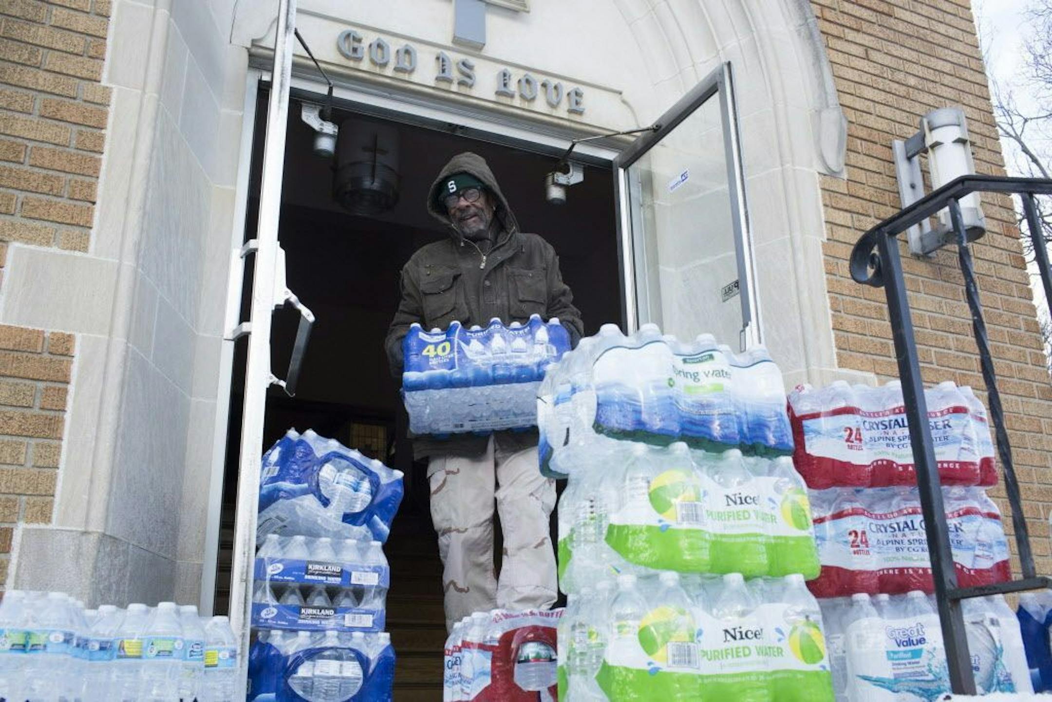 Maurice Rice organizes cases of water at the Joy Tabernacle Church on Monday, Jan. 11, 2016, in Flint, Mich. Michigan Gov. Rick Snyder pledged Monday that officials would make contact with every household in Flint to check whether residents have bottled water and a filter and want to be tested for lead exposure while his embattled administration works on a long-term solution to the city's water crisis. (Conor Ralph/The Flint Journal-MLive.com via AP) LOCAL TELEVISION OUT; LOCAL INTERNET OUT; MAN