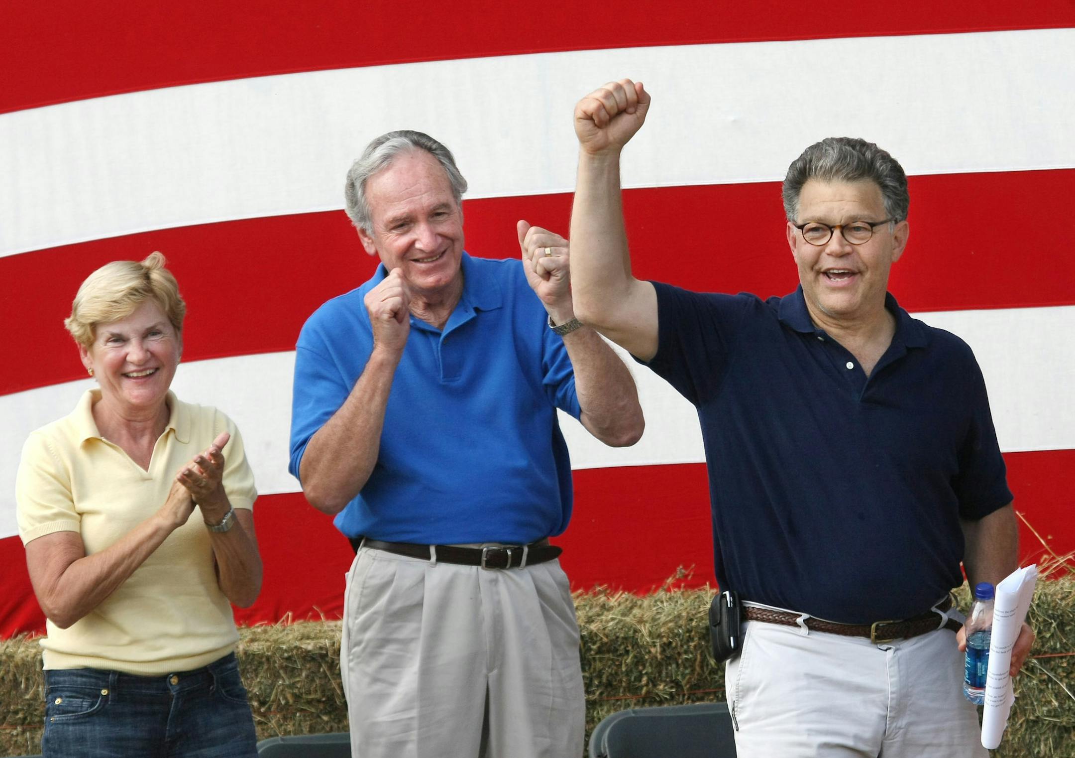Minnesota Sen. Al Franken, right, receives applause from Ruth and Iowa Sen. Tom Harkin following Franken's remarks at the 32nd Harkin Steak Fry Sunday, Sept. 13, 2009, in Indianola, Iowa. (AP Photo/The Des Moines Register, Mary Chind) ** MANDATORY CREDIT. MAGS OUT. NO SALES. **
