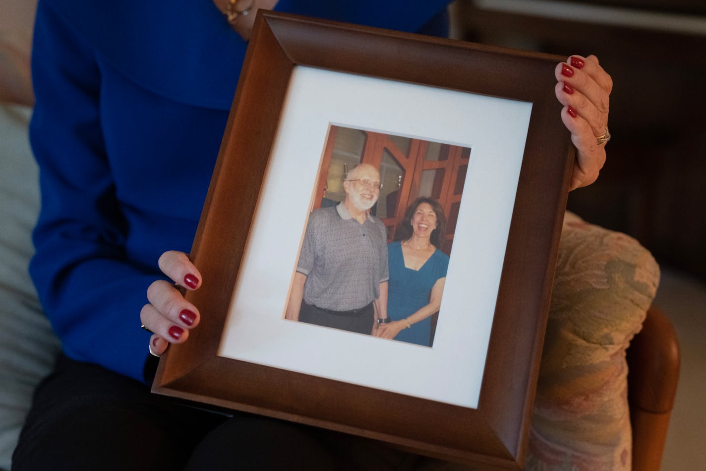 Ellen Kennedy held a photo of her late husband, Leigh Lawton, who died from cancer in 2022. It was Lawton's dying wish that Kennedy advocate for a law in Minnesota to legalize medical aid in dying. Photo by Alex Kormann, Star Tribune.