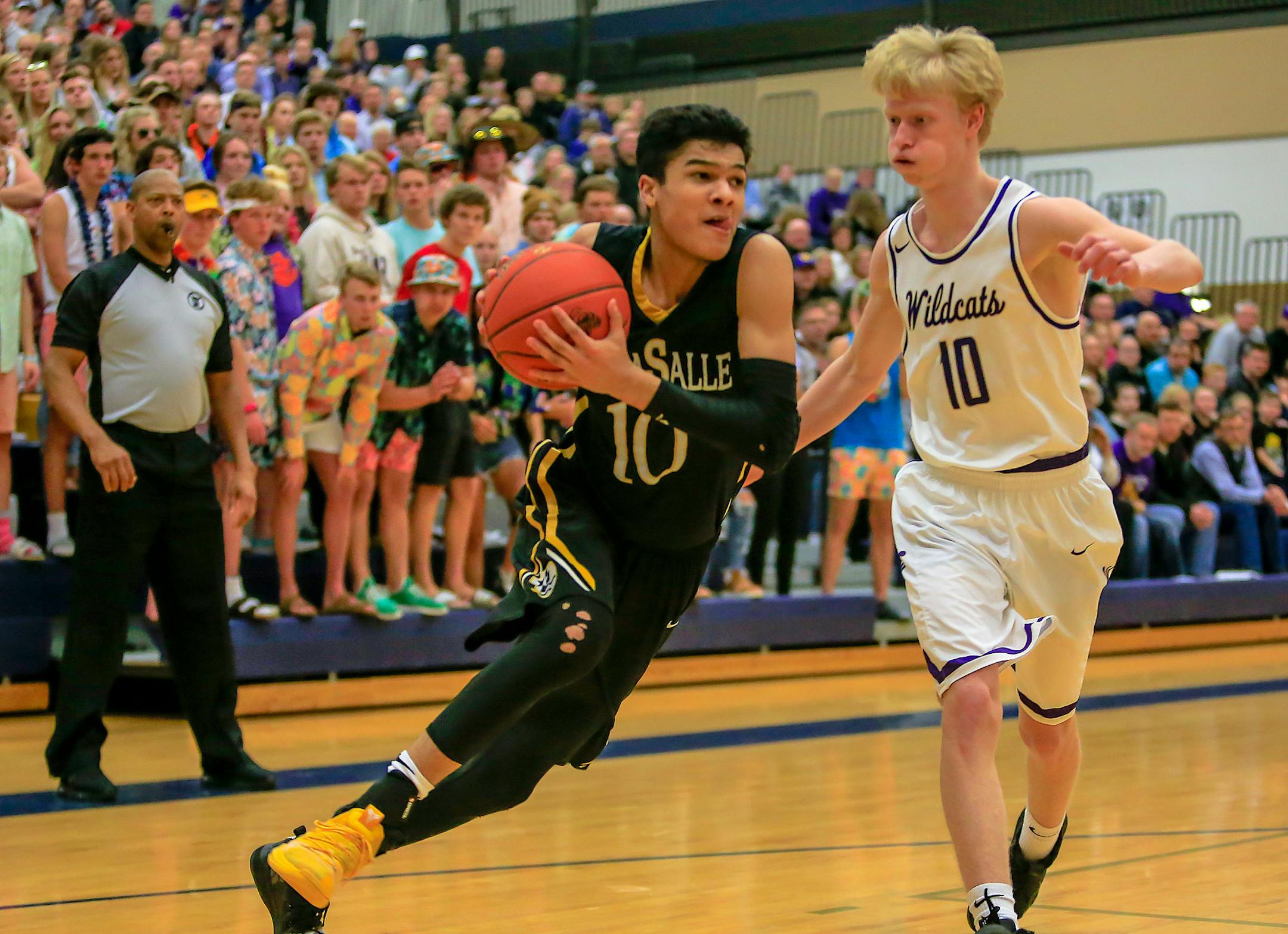 DeLaSalle'sTyrell Terry (10) drives on Waconia's Ryan Biehn late in the second half. Terry was fouled on the drive and made two free throws in the Islanders' 78-63 victory in a Class 3A Section 6 final at Chanhassen High School. Terry scored a team-high 25 points. Photo by Mark Hvidsten, SportsEngine