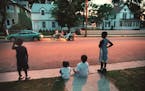 1996: On a warm summer night, kids gathered on the curb on the 2600 block of Colfax Avenue N. to watch as a neighbor tried out a new motortricycle.