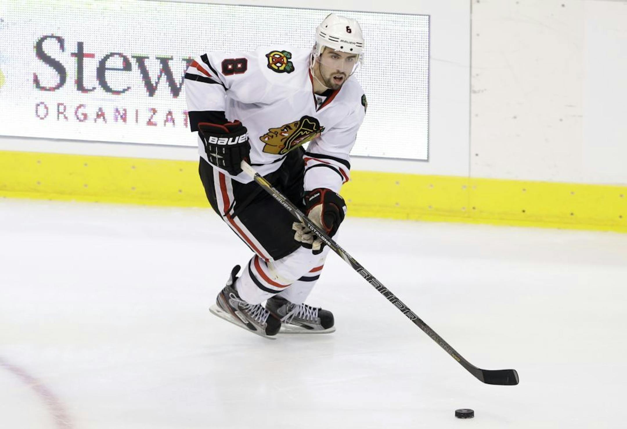 Chicago Blackhawks' Nick Leddy (8) controls the puck during an NHL hockey game against the Dallas Stars Thursday, Jan. 24, 2013, in Dallas. The Blackhawks won in overtime 3-2.