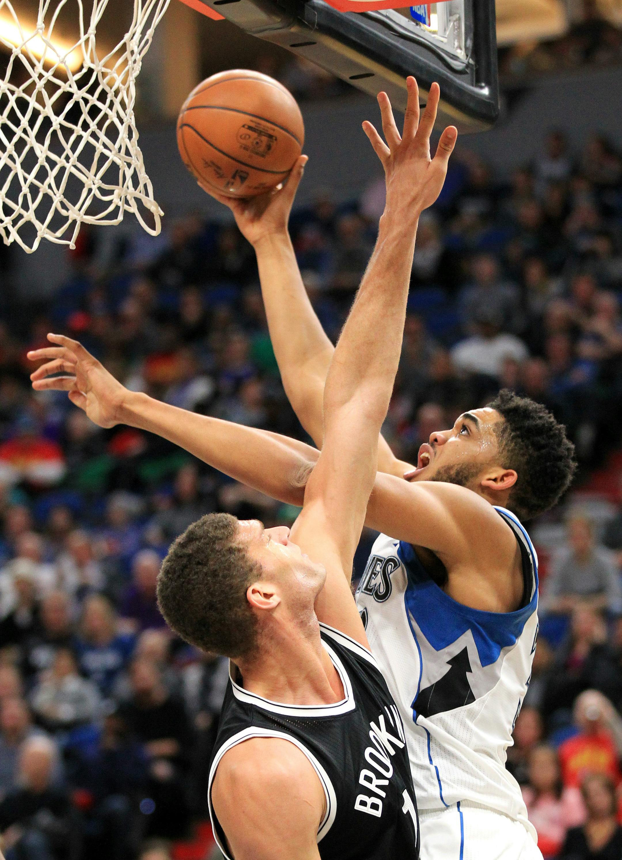 Minnesota Timberwolves center Karl-Anthony Towns (32) shoots over Brooklyn Nets center Brook Lopez during the third quarter of an NBA basketball in Minneapolis, Saturday, Jan. 28, 2017. The Timberwolves defeated the Nets 129-109. (AP Photo/Andy Clayton-King)