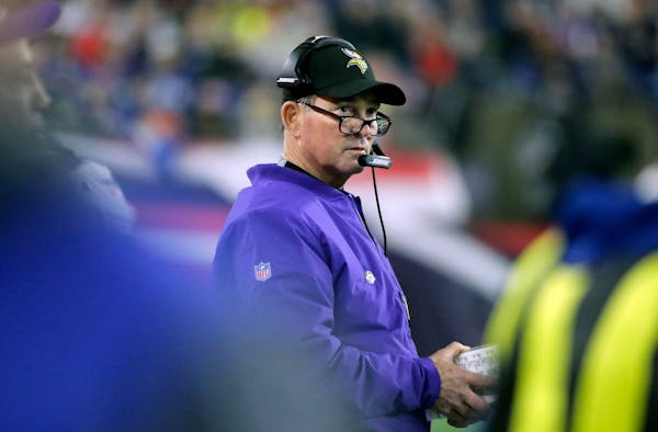 Vikings head coach Mike Zimmer watches from the sideline during the first half against the New England Patriots