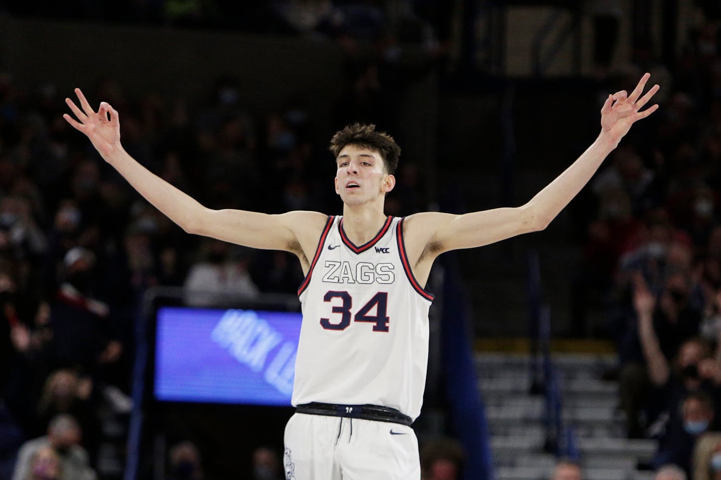 Gonzaga center Chet Holmgren celebrates a basket by guard Julian Strawther during the second half of the team's NCAA college basketball game against Saint Mary's, Saturday, Feb. 12, 2022, in Spokane, Wash. Gonzaga won 74-58. (AP Photo/Young Kwak)