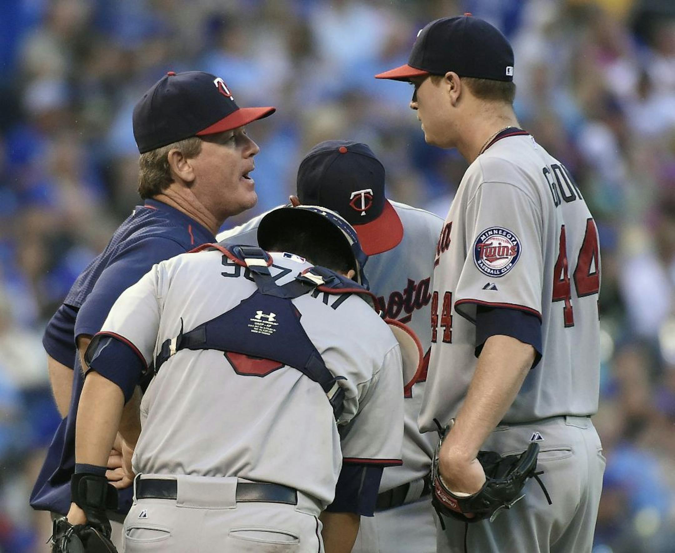 Minnesota Twins pitching coach Neil Allen makes a visit to the mound to talk with starting pitcher Kyle Gibson (44) in the fourth inning against the Kansas City Royals. Gibson pitched eight shutout innings.