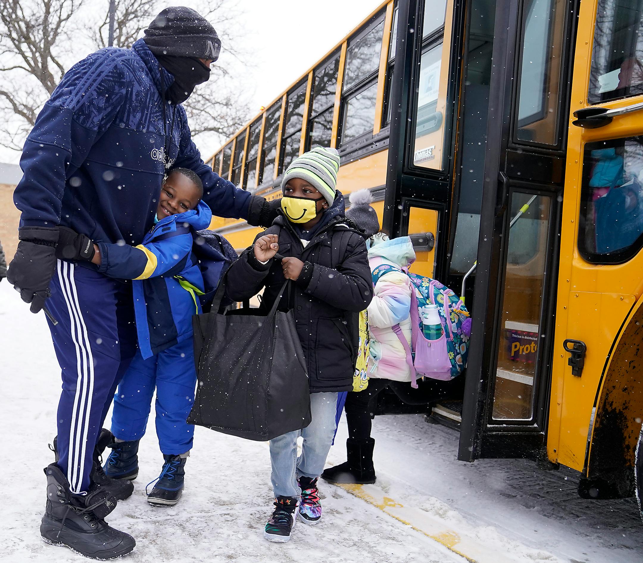 In person learning returned for kindergarten through second graders at Sonnesyn Elementary School Tuesday in New Hope. Here, Robbinsdale school district staff member Rodney Lewis greeted students stepping of a school bus on the first day of in-classroom learning Tuesday.