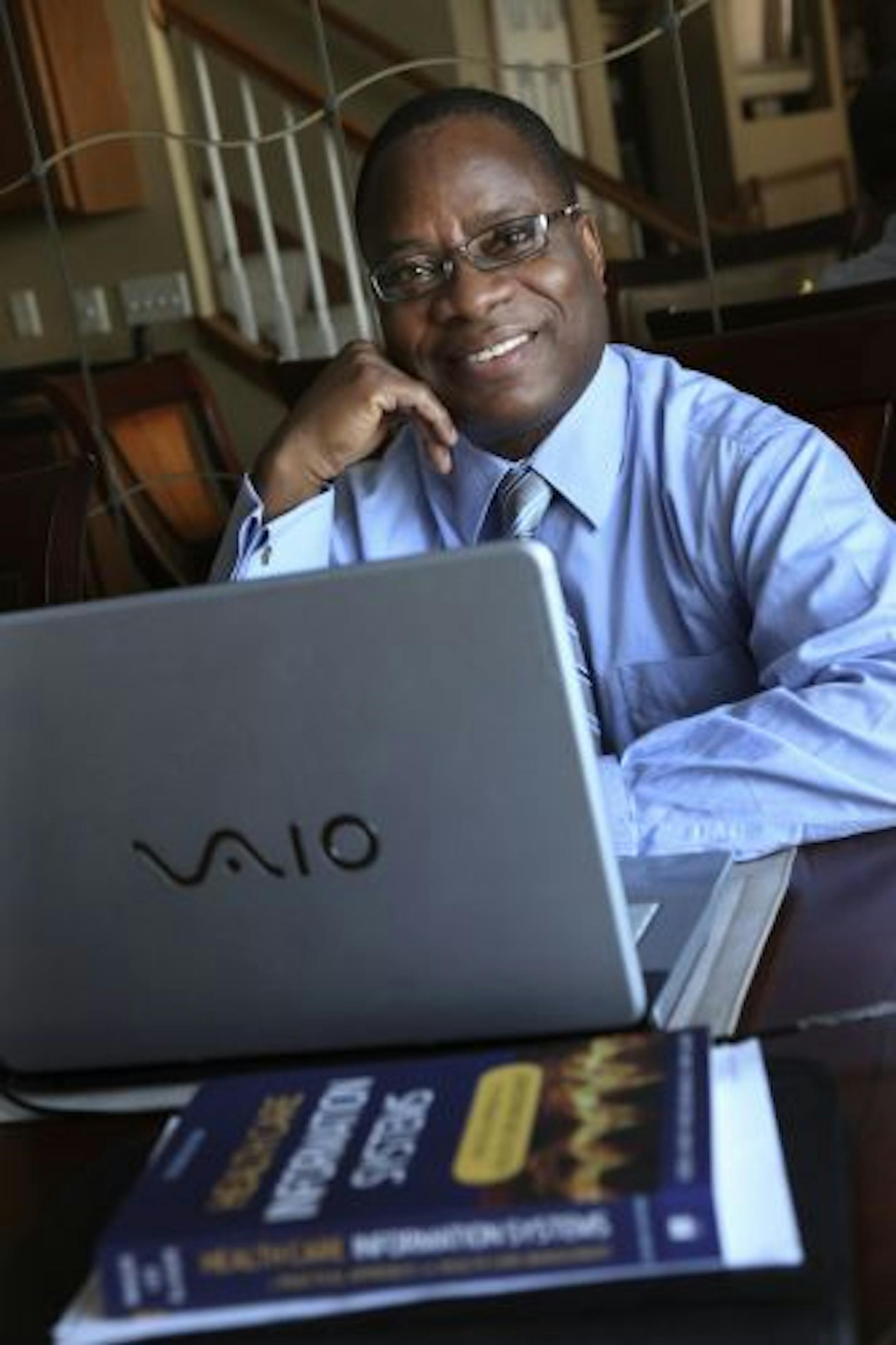 Michael Taiwo has transformed his dining room table into his school desk as remake his career in the health care sector after getting laid off. Taiwo is taking an online course in health information technology.