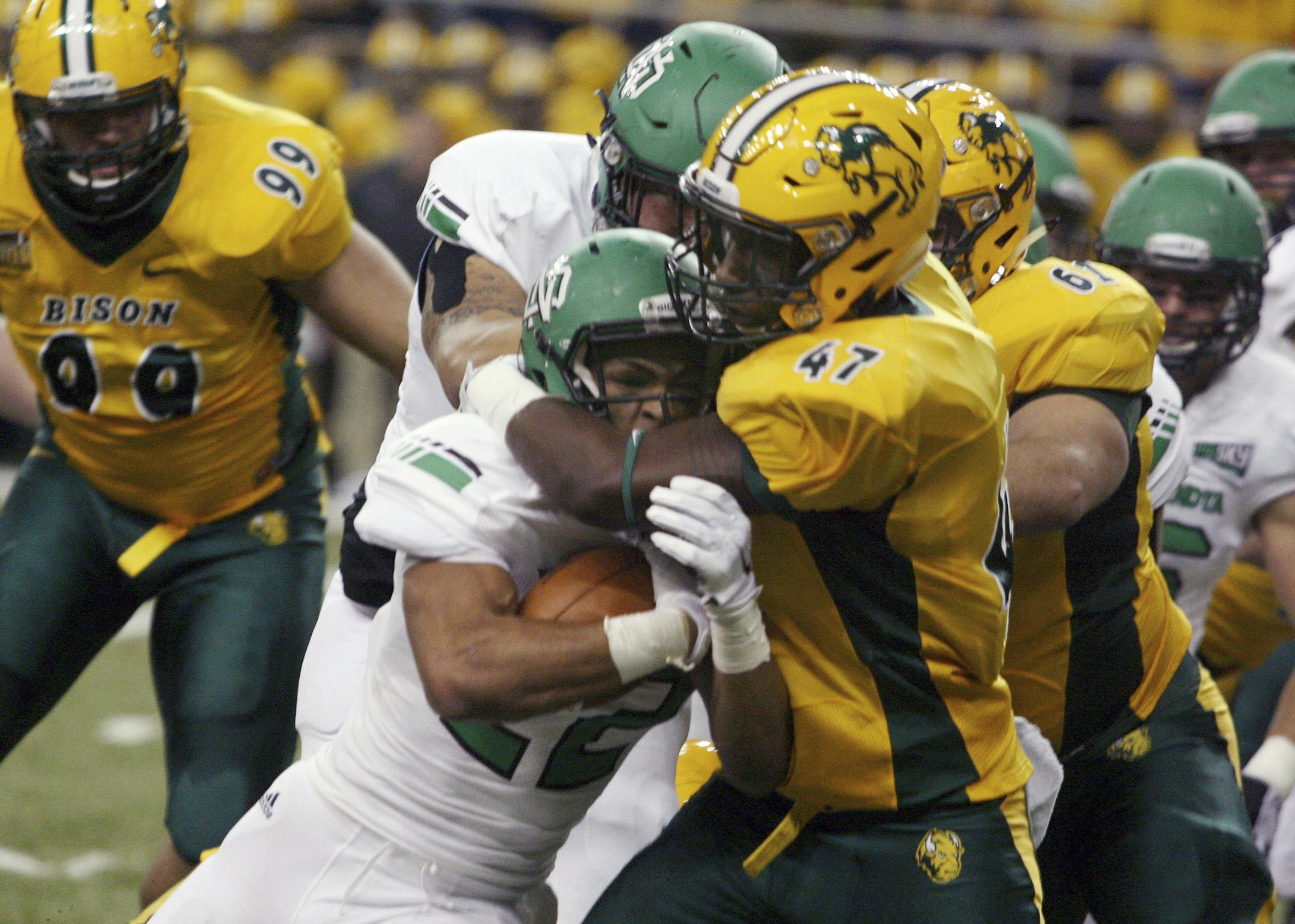North Dakota State defender Pierre Gee-Tucker (47) stops North Dakota running back John Santiago during the first half of an NCAA college football game Saturday, Sept. 19, 2015, in Fargo, N.D. (AP Photo/Bruce Crummy)