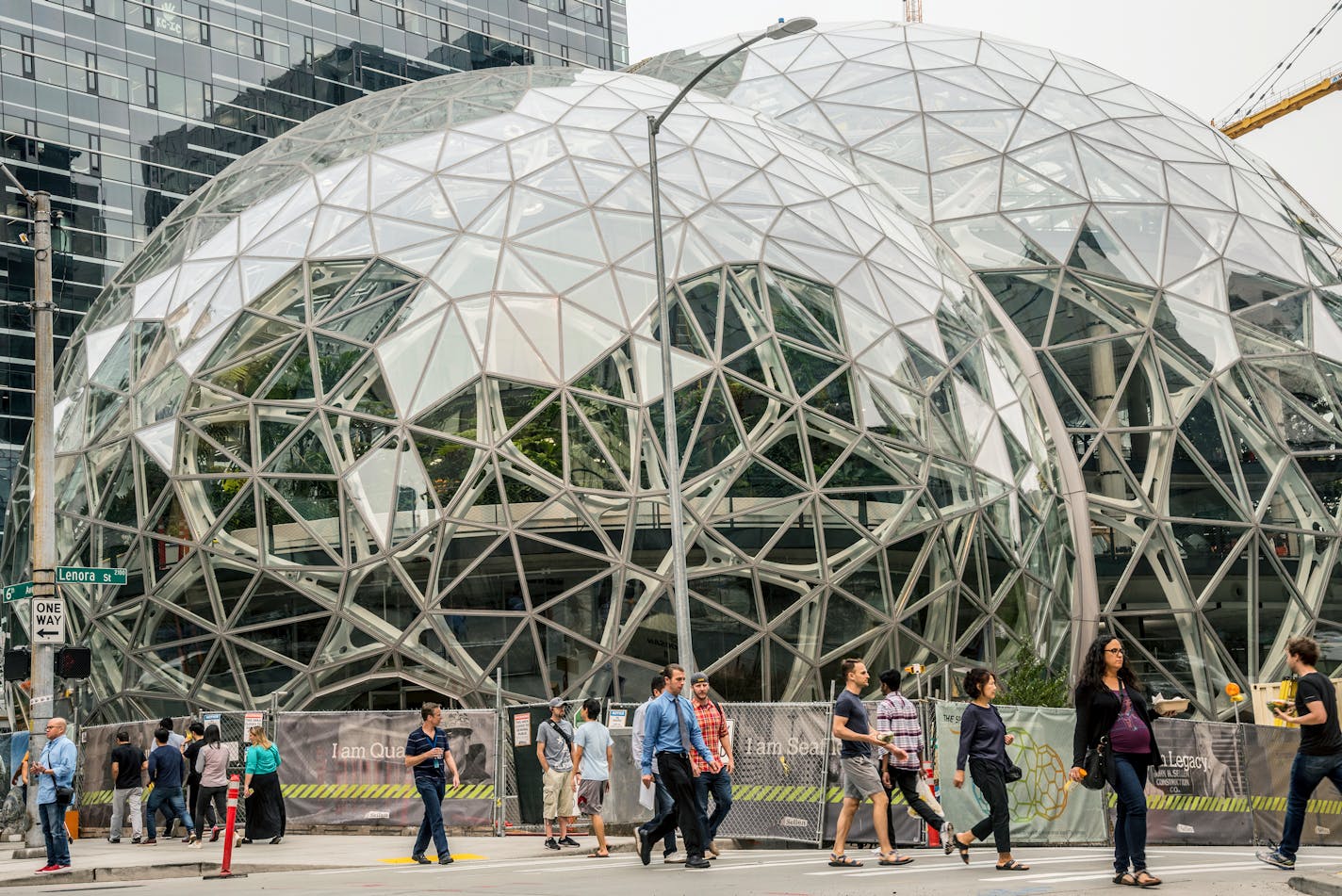 Pedestrians walk past a recently built trio of geodesic domes that are part of the Seattle headquarters for Amazon, Sept. 7, 2017. The online retail giant said it was searching for a second headquarters in North America in 2017, a huge new development that would cost as much as $5 billion to build and run, and house as many as 50,000 employees. (Stuart Isett/The New York Times)