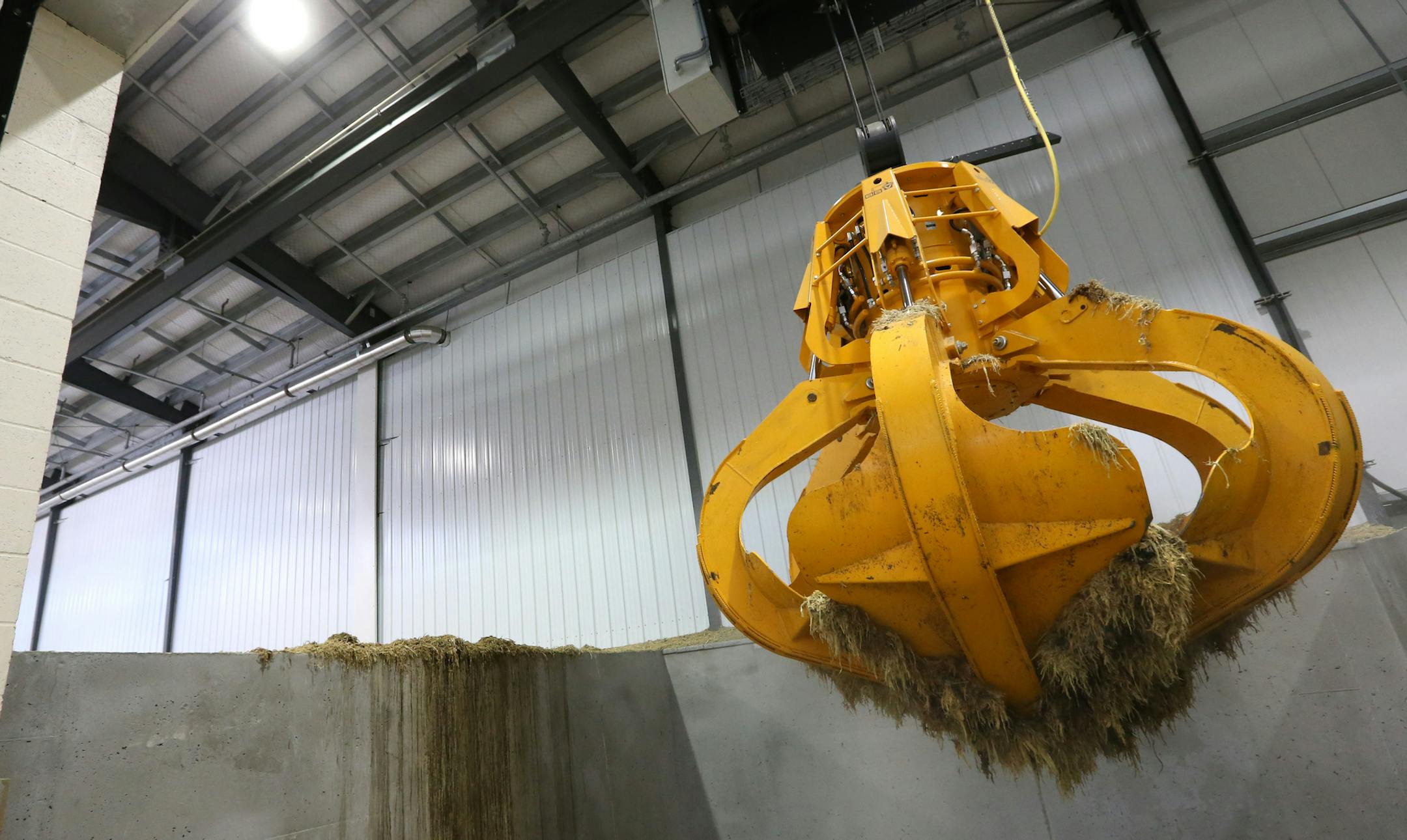 A large robot claw picked up sileage to be put in the processing system at the Hometown Bioenergy plant in Le Sueur, Minn.