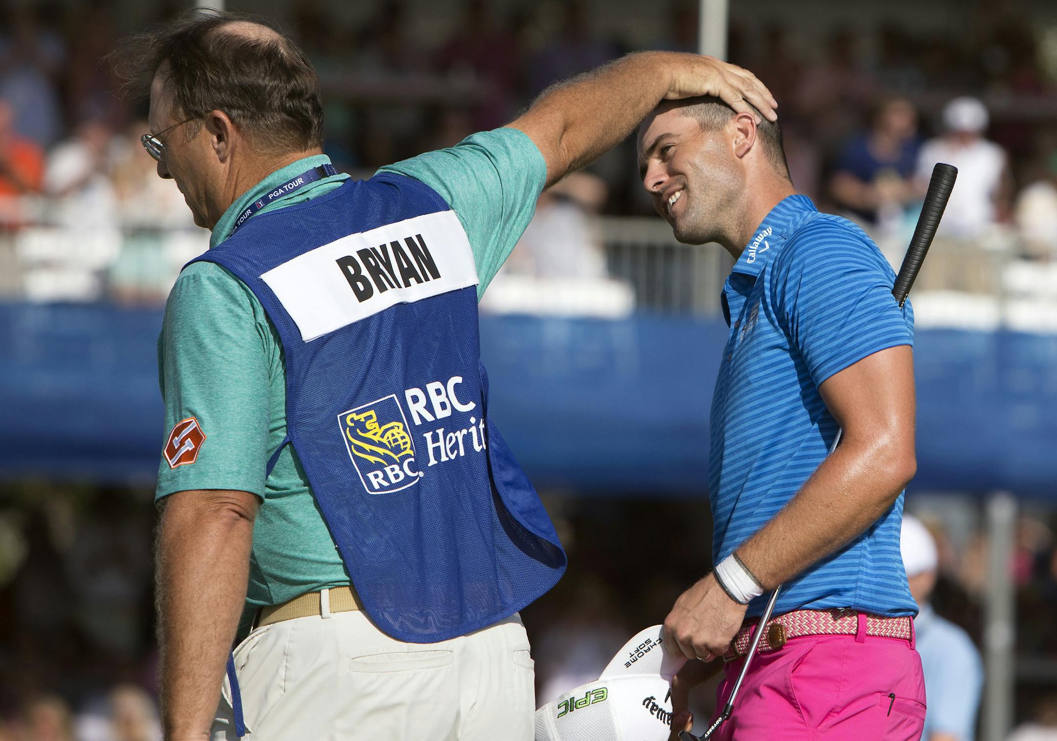 Wesley Bryan, right, is congratulated by his caddie William Lanier, left, after Bryan won the RBC Heritage golf tournament in Hilton Head Island, S.C., Sunday, April 16, 2017. (AP Photo/Stephen B. Morton)