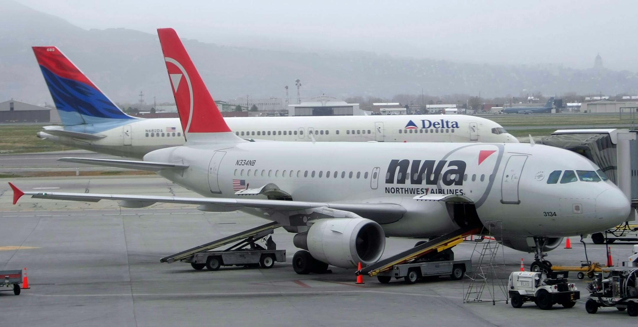 SALT LAKE CITY, UT - APRIL 15: (FILE PHOTO) A Delta plane taxies as a Northwest plane sits at the gate at the Salt Lake International Airport on April 15, 2008 in Salt Lake City, Utah. It was announced on April 23, 2008 that Atlanta-based Delta Air Lines Inc. reported a first quarter $6.39 billion loss, citing the surge in rising fuel costs, while Northwest lost 4.1 billion.