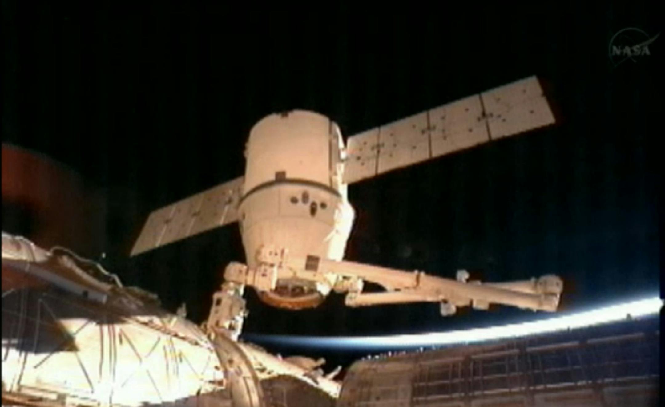 This image provided by NASA-TV shows the SpaceX Dragon commercial cargo craft after it was detached from the International Space Station early Tuesday March 26, 2013 by the International Space Station's Canadarm2 robotic arm. The two spacecraft were traveling Canada at the time. The rising sun and the curvature of the earth can be seen behind the spacecraft. The Dragon is expected to splash down in the eastern Pacific ocean approximately 246 miles off the coast of Baja Calif., later this morning