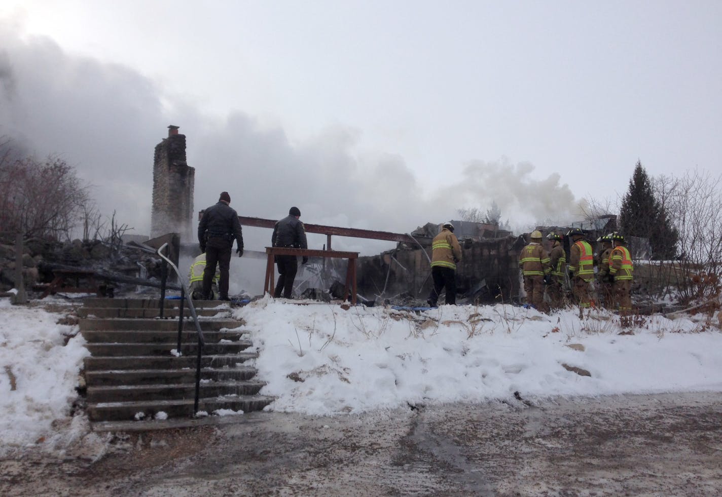 Authorities examine what's left of the restaurant at the clubhouse of the Minnesota Horse and Hunt Club in Prior Lake after fire erupted before dawn Tuesday.