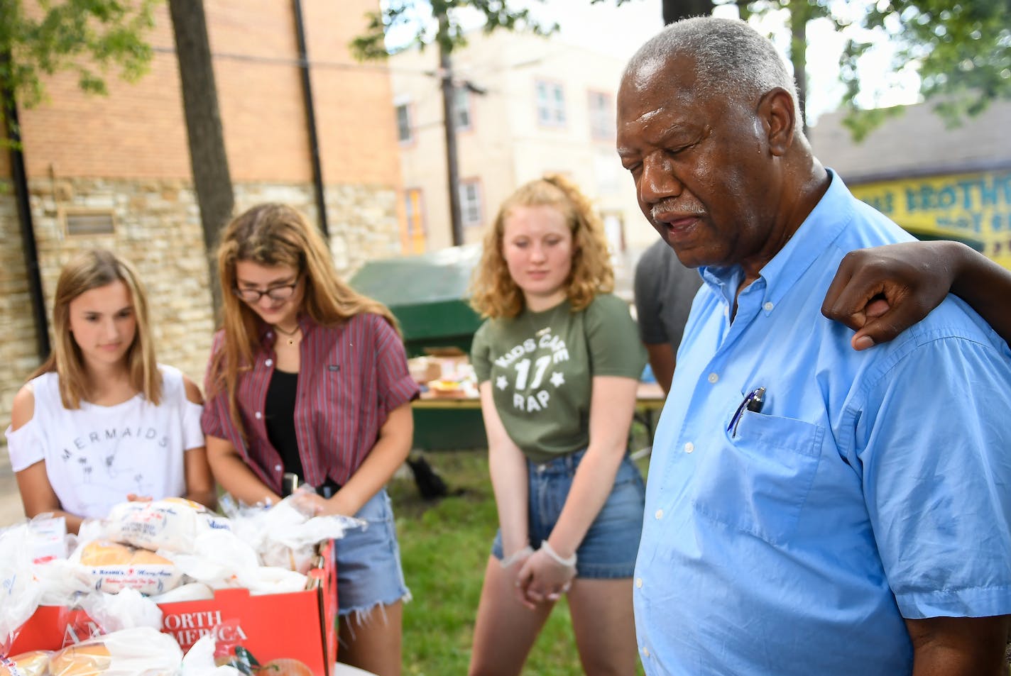 Rev. Kelly Chatman led a before-meal prayer during Wednesday night's community cookout at Redeemer Lutheran Church. ] AARON LAVINSKY &#xef; aaron.lavinsky@startribune.com At picturesque Vasa Church, one of the first Lutheran churches in Minnesota, the rural congregation is preparing for a Scandinavian midsummer festival complete with Swedish pancakes. At Redeemer Lutheran in north Minneapolis, summer means the church bike shop is humming, the health commons offers yoga and zumba, the kids' camp