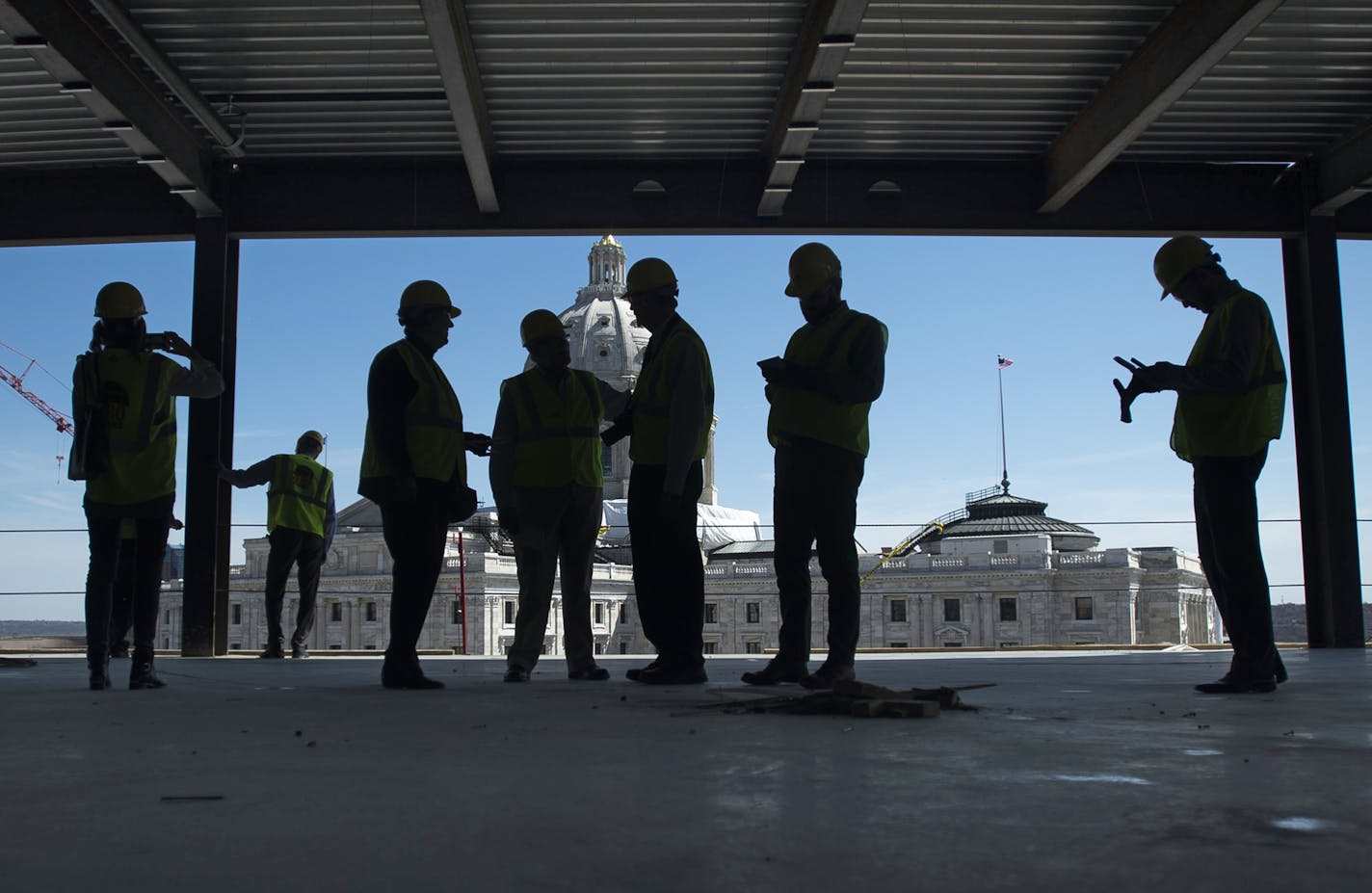 Members of the media and Mortenson Construction employees stand around the top floor of the new Senate Office Building during a tour on Tuesday afternoon. ] (Aaron Lavinsky | StarTribune) aaron.lavinsky@startribune.com Mortenson Construction gave the media a tour of the new Senate Office Building construction, a project that has been criticized over spending by Republicans. The building is being built in conjunction with the capitol renovation and will house senators displaced by the capitol pro