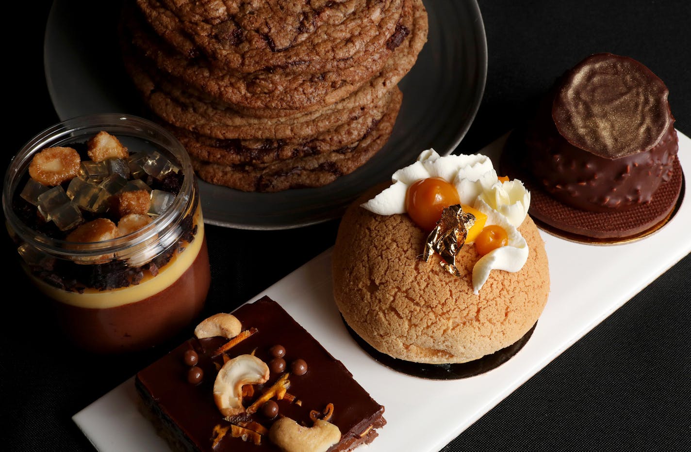 Desserts, clockwise from left, passion fruit chocolate mousse, gluten free salted chocolate chip cookies, a rocher with hazelnut chocolate mousse and candied hazelnuts, a coconut mango cream pie puff, and a curried scotcheroo. ] ANTHONY SOUFFLE &#xef; anthony.souffle@startribune.com Schwan's Co. is creating the ultimate dessert destination, the Edwards Dessert Kitchen, in the North Loop of Minneapolis. The restaurant will serve as a test kitchen for the Minnesota-based company to experiment with