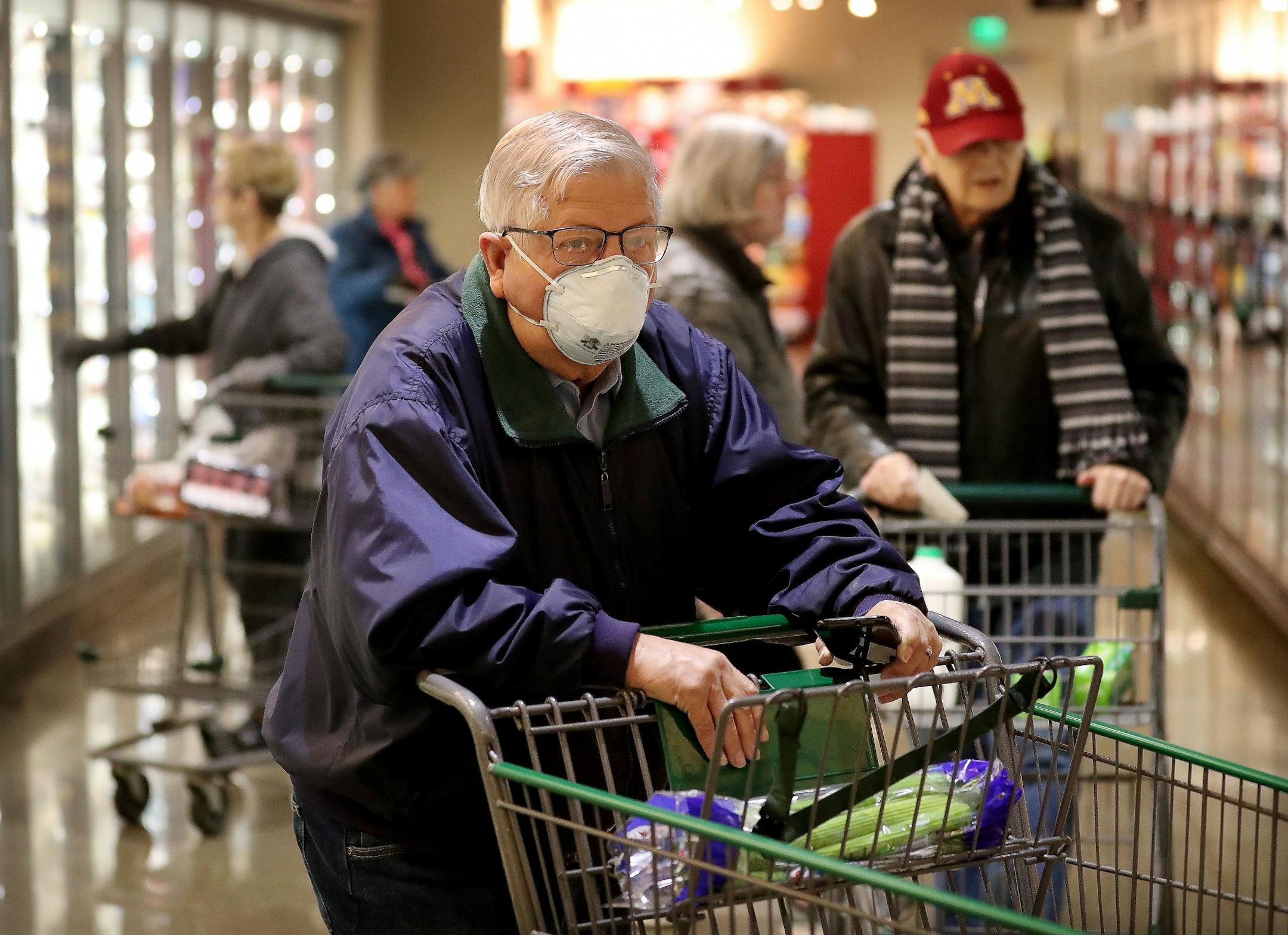 Shopper Merlin Smith, 82, of Edina navigates the aisles of Lunds and Byerlys during an early morning hour devoted to older shoppers and shoppers with health conditions Thursday, March 19, 2020, in Edina, MN. Smith was also shopping for his wife who has heart issues and was home. He also has heart disease and said having the early hour to grocery shop when it is void of crowds gives him peace of mind.