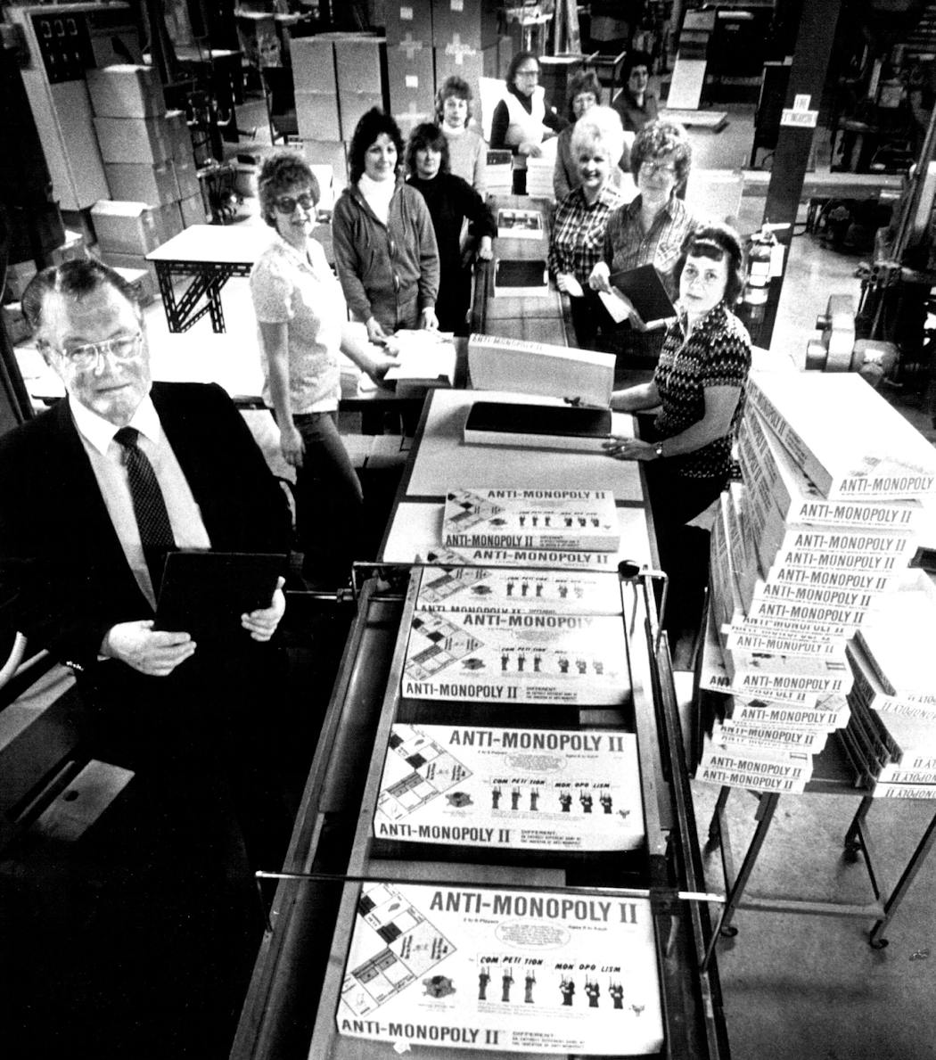 Russ Foster, left, posed with Mankato Corporation workers assembling Anti-Monopoly's sequel, Anti-Monopoly II, in 1983.