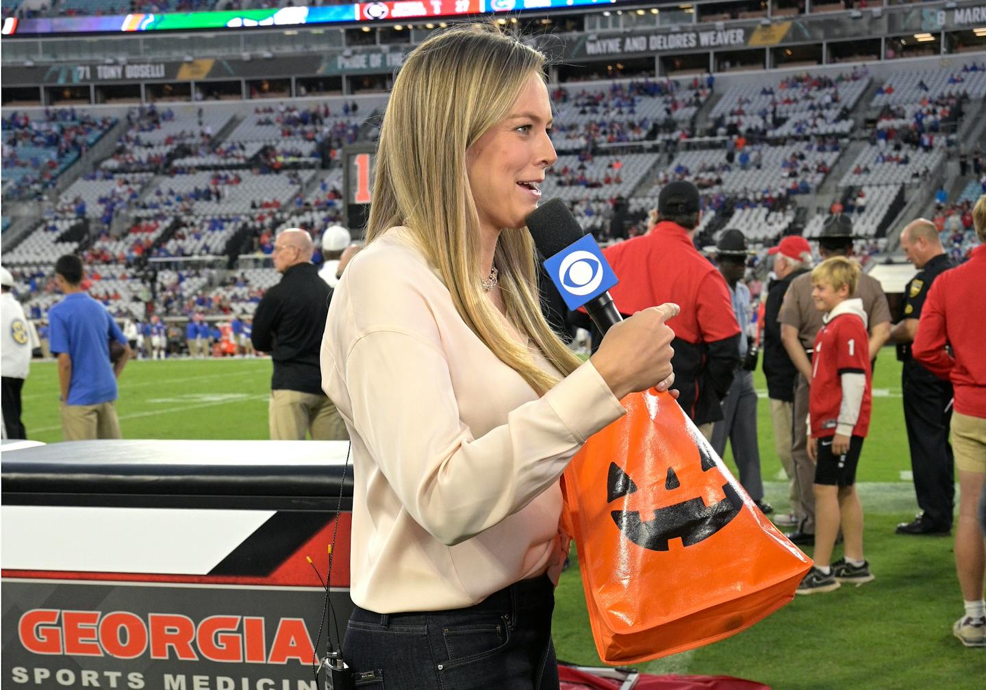 CBS sideline reporter Jamie Erdahl works behind the Georgia bench during the second half of an NCAA college football game against Florida, Saturday, Oct. 30, 2021, in Jacksonville, Fla. (AP Photo/Phelan M. Ebenhack)