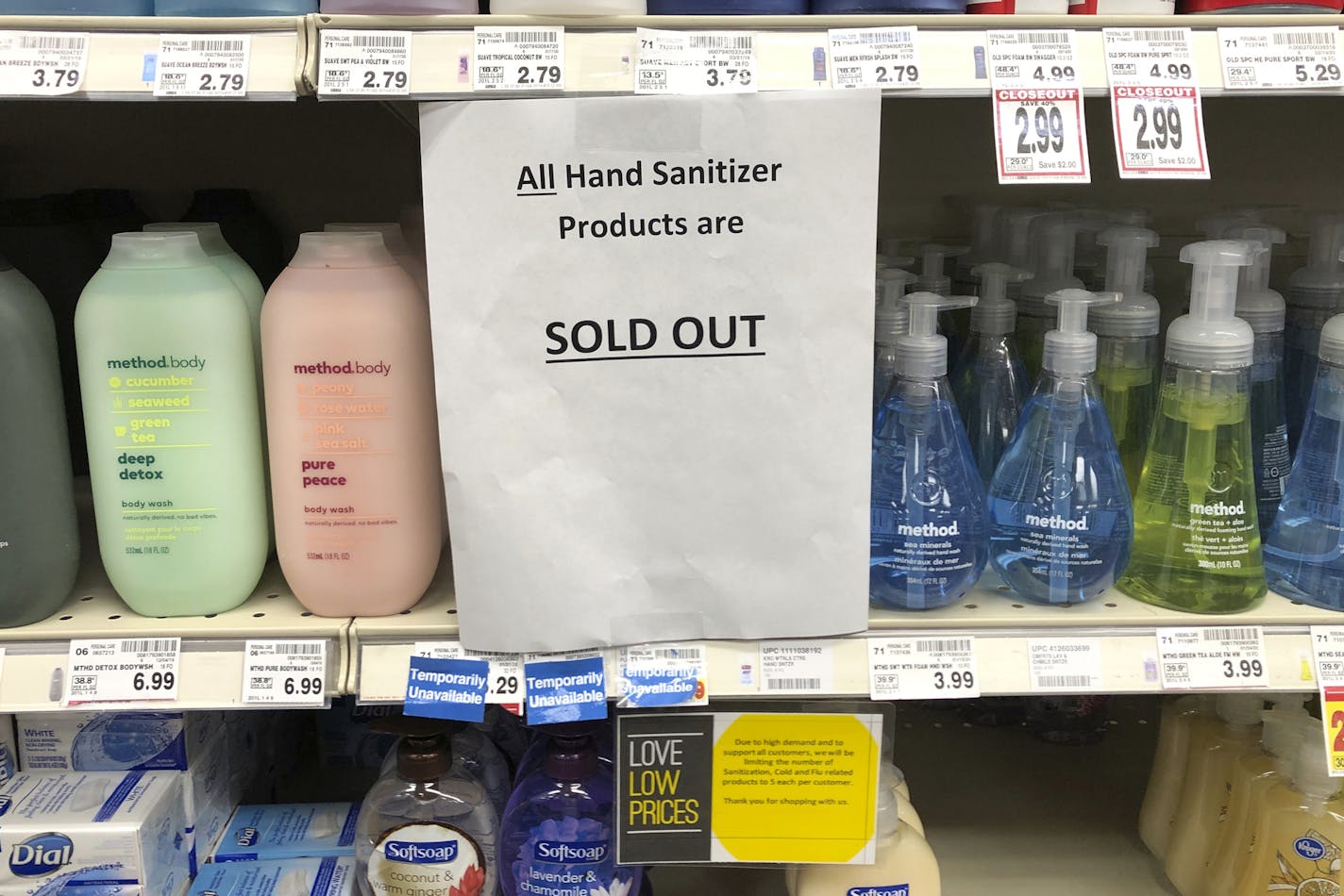 A sign on a shelf at a QFC grocery store in Kirkland, Wash., advises shoppers Tuesday, March 3, 2020 that all hand sanitizer products are sold out. Fear of the coronavirus has led people to stock up on the germ-killing gel, leaving store shelves empty and online retailers with sky-high prices set by those trying to profit on the rush. The store is located near the Life Care Center of Kirkland, which has been tied to several cases of the COVID-19 coronavirus. (AP Photo/Ted S. Warren)