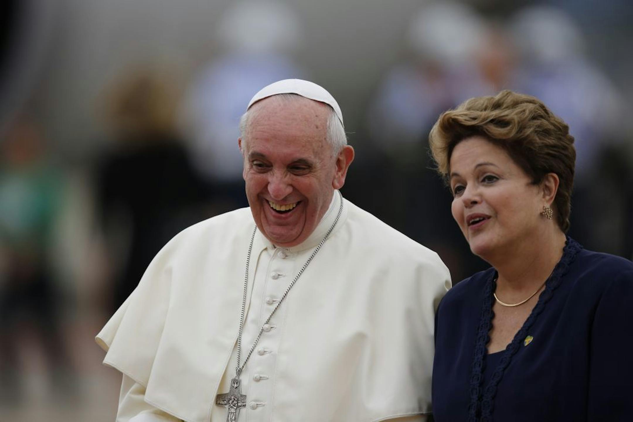 Pope Francis and Brazil's President Dilma Rousseff smile as she accompanies him upon his arrival at the international airport in Rio de Janeiro, Brazil, Monday, July 22, 2013.