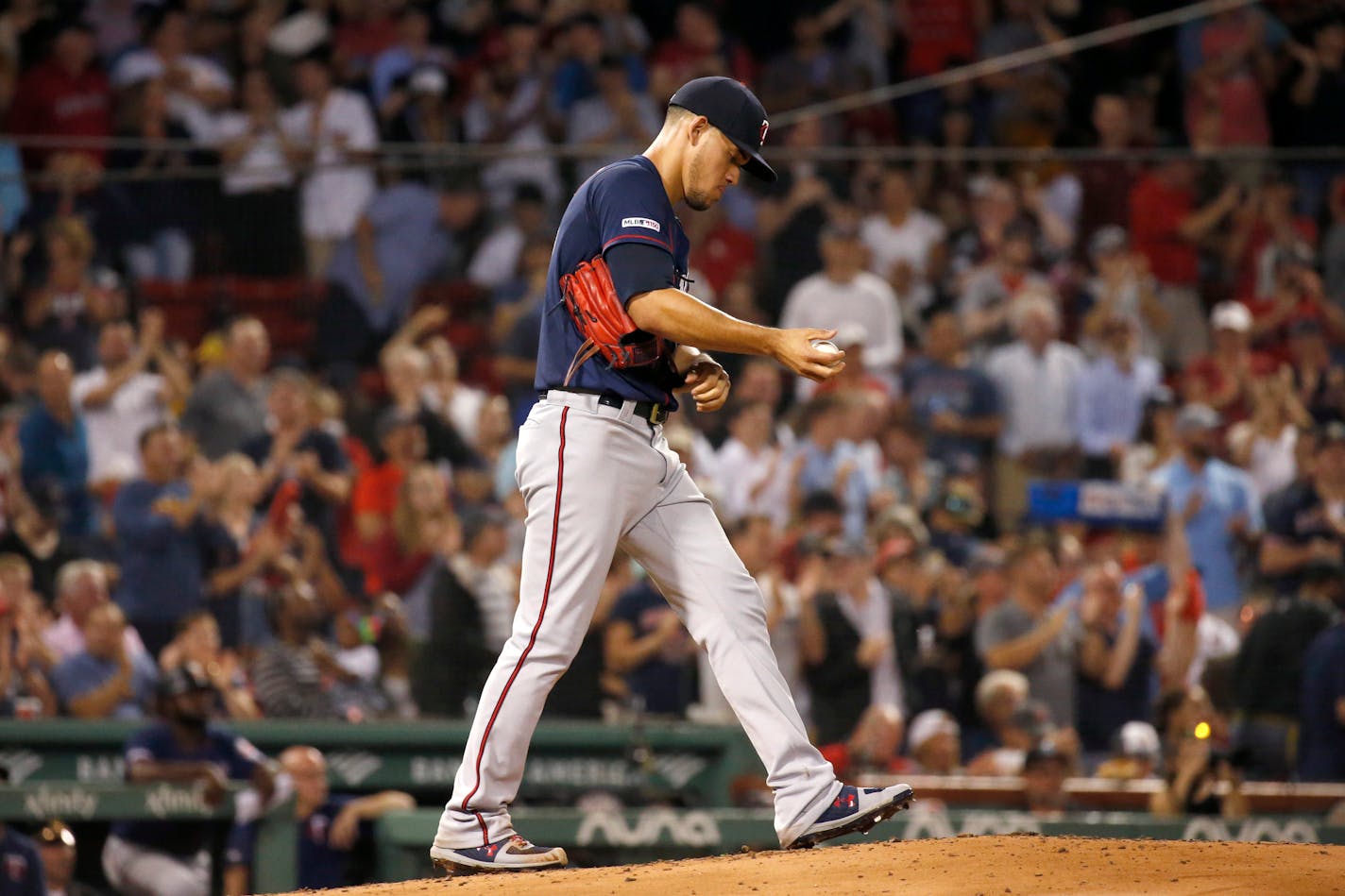 Twins starting pitcher Jose Berrios reacts after giving up a three-run home run to Boston's Mookie Betts during the second inning