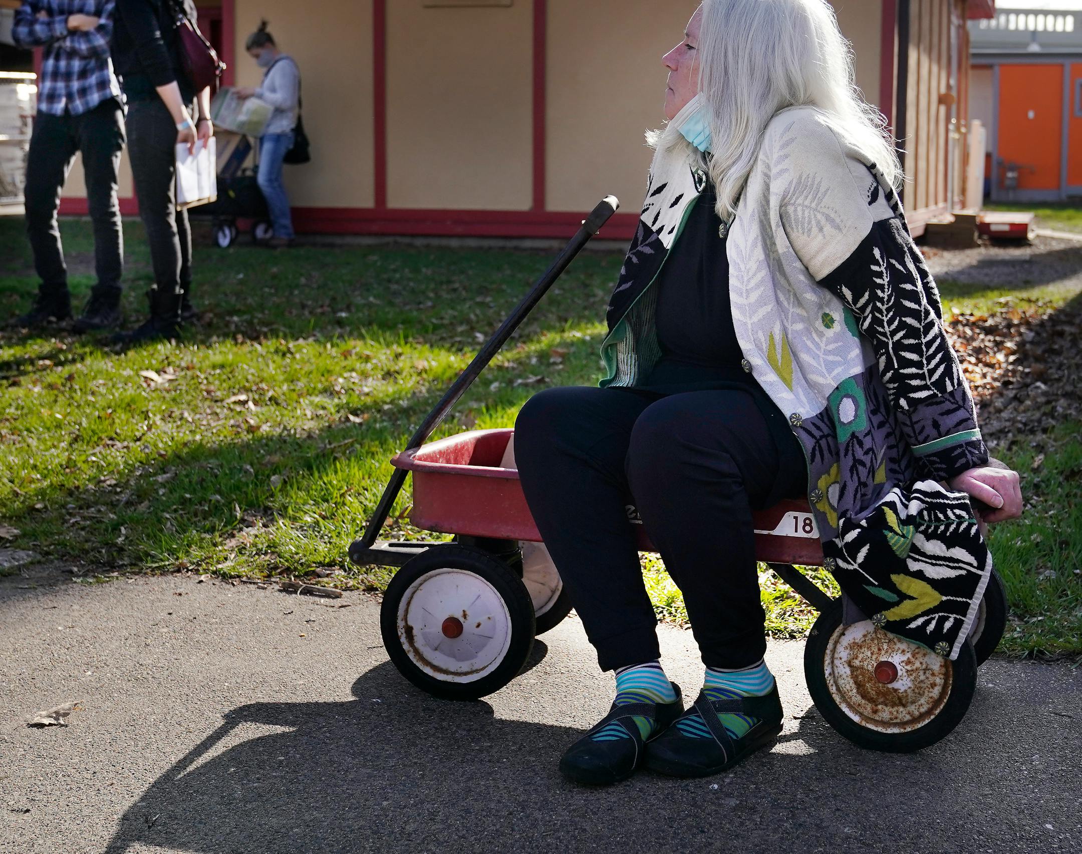 Gardener Mary Rush of St. Paul took a seat in her wagon used to haul plants before the opening of the Friends School of Minnesota fundraiser plant sale.