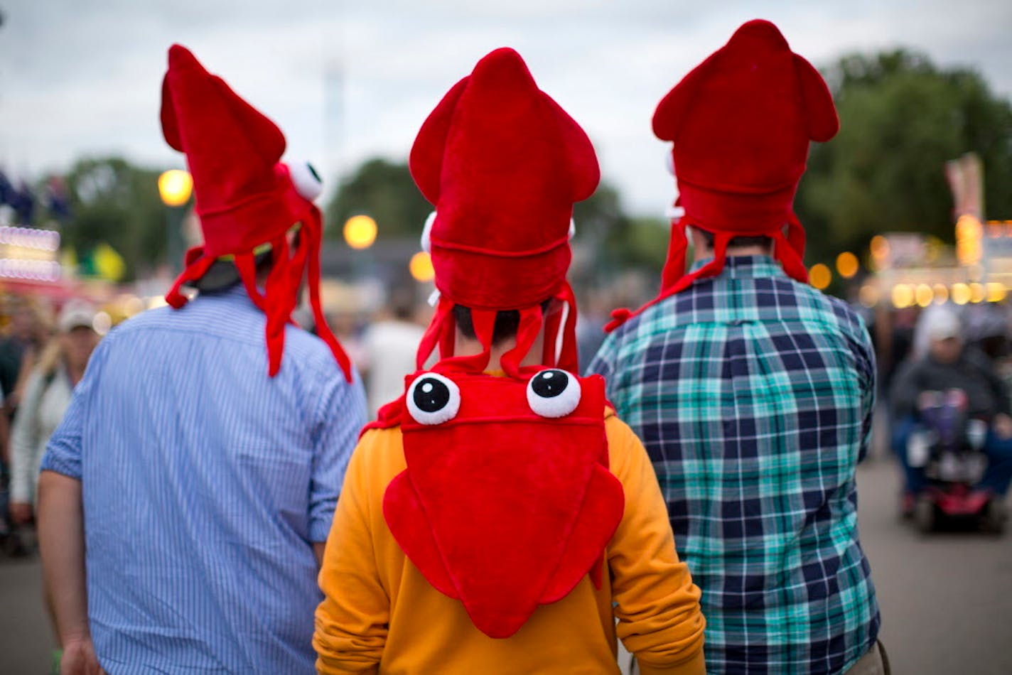 Three men wearing squid hats and walked on Judson Ave. during the 2013 fair.