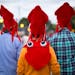 Three men wearing squid hats and walked on Judson Ave. during the 2013 fair.