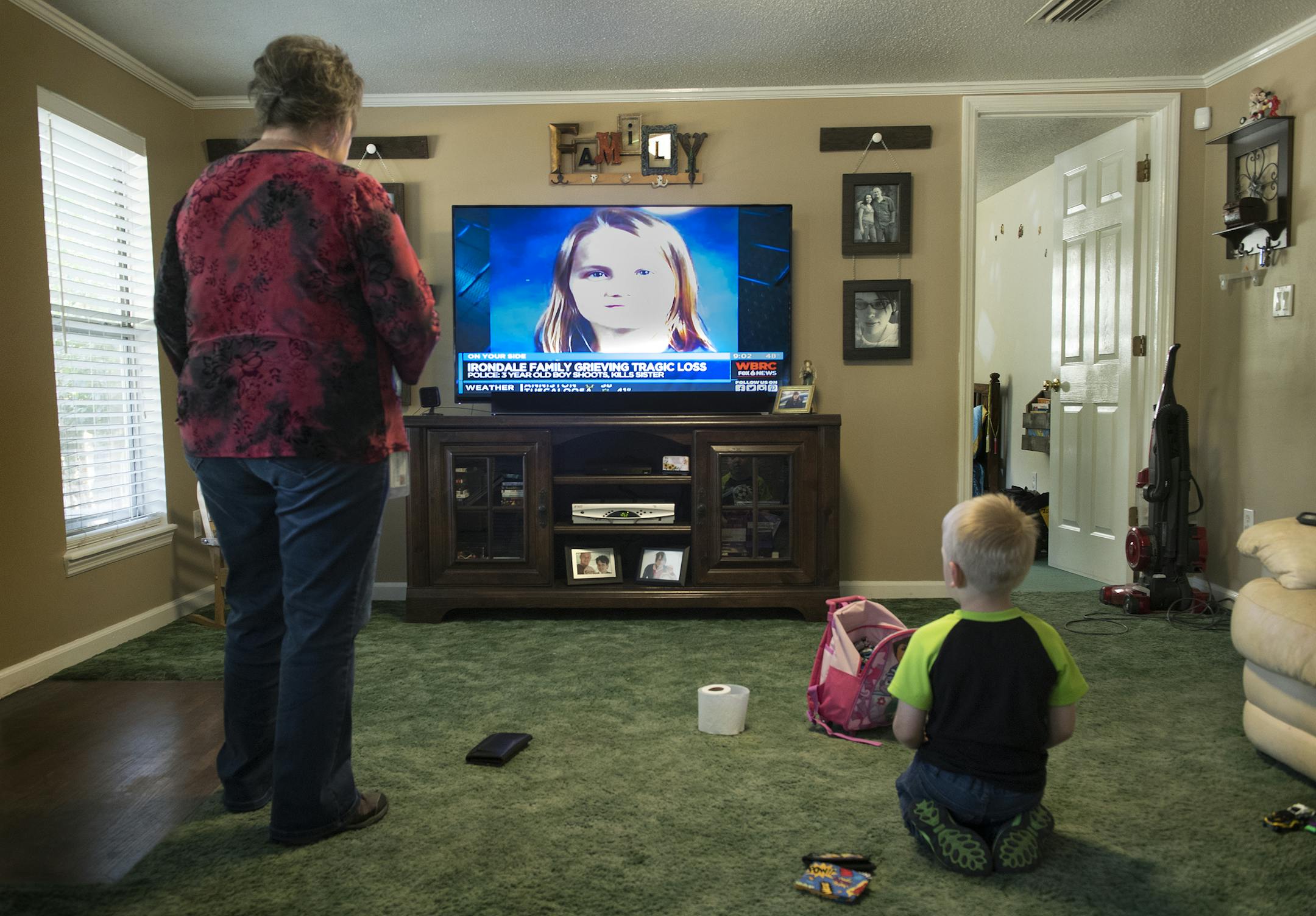 Tina Watson sometimes watches a taped news report about the shooting to remember Kimi and as a way to help Jaxon understand what happened. Must credit: Washington Post photo by Linda Davidson