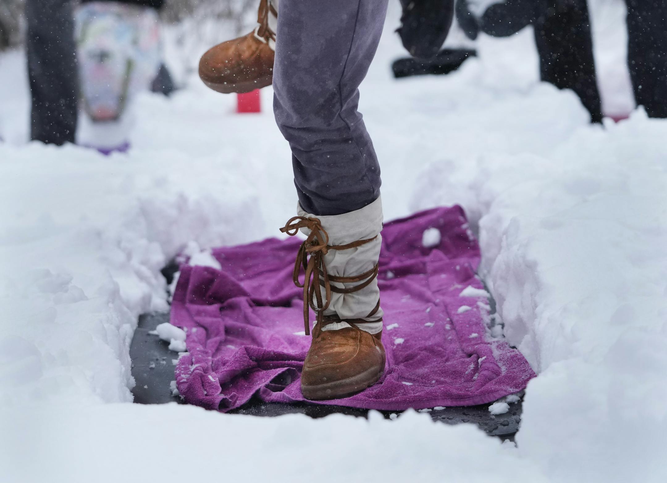 Snowga participants traded boots for bare feet while participating in the Yoga in the Gardens series at the Lilac Walk in the Minnesota Landscape Arboretum.