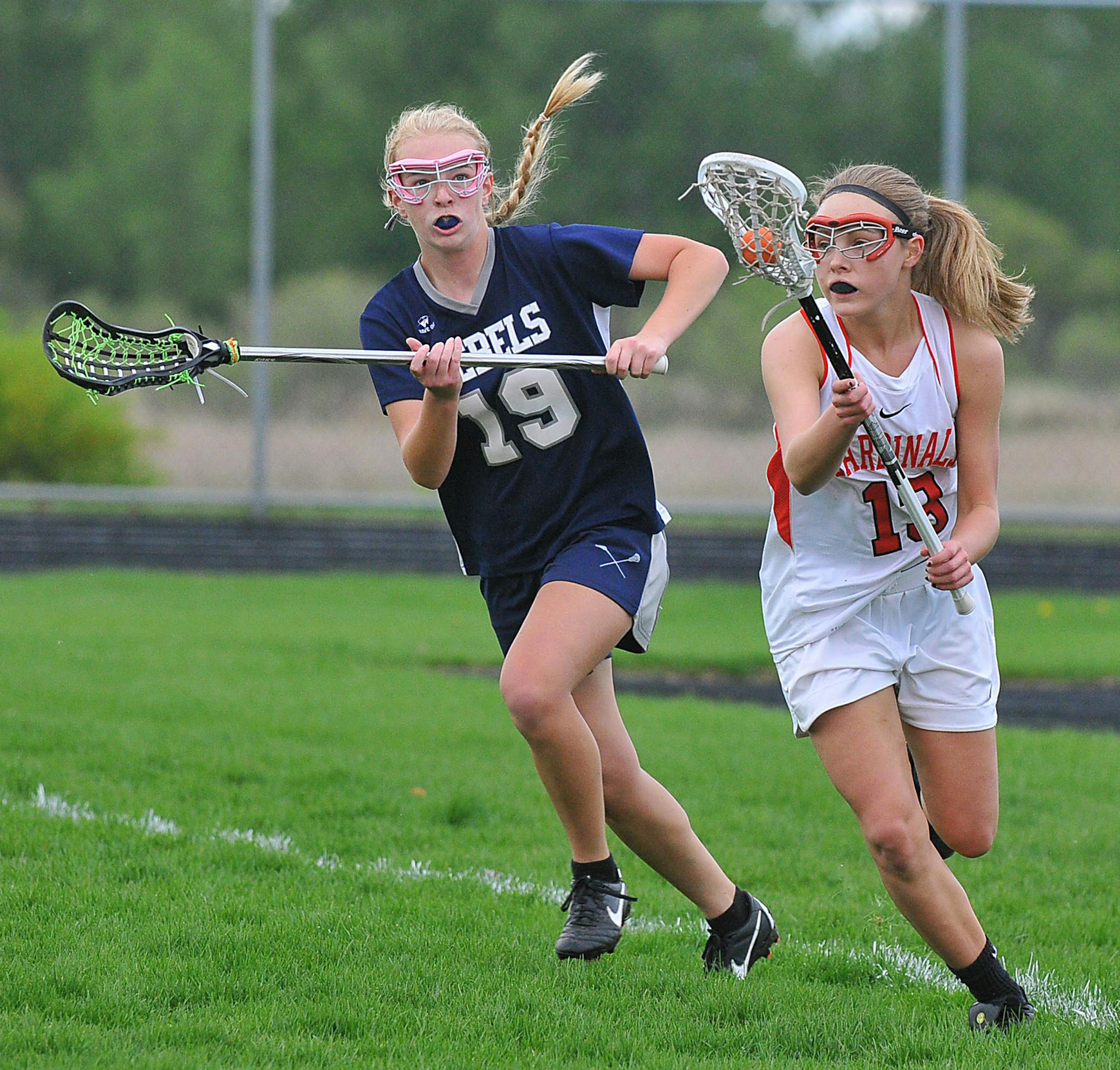 Coon Rapids' Emily Boyum (13), Champlin Park's Jessi Kelley (19). Photo by Rick Orndorf