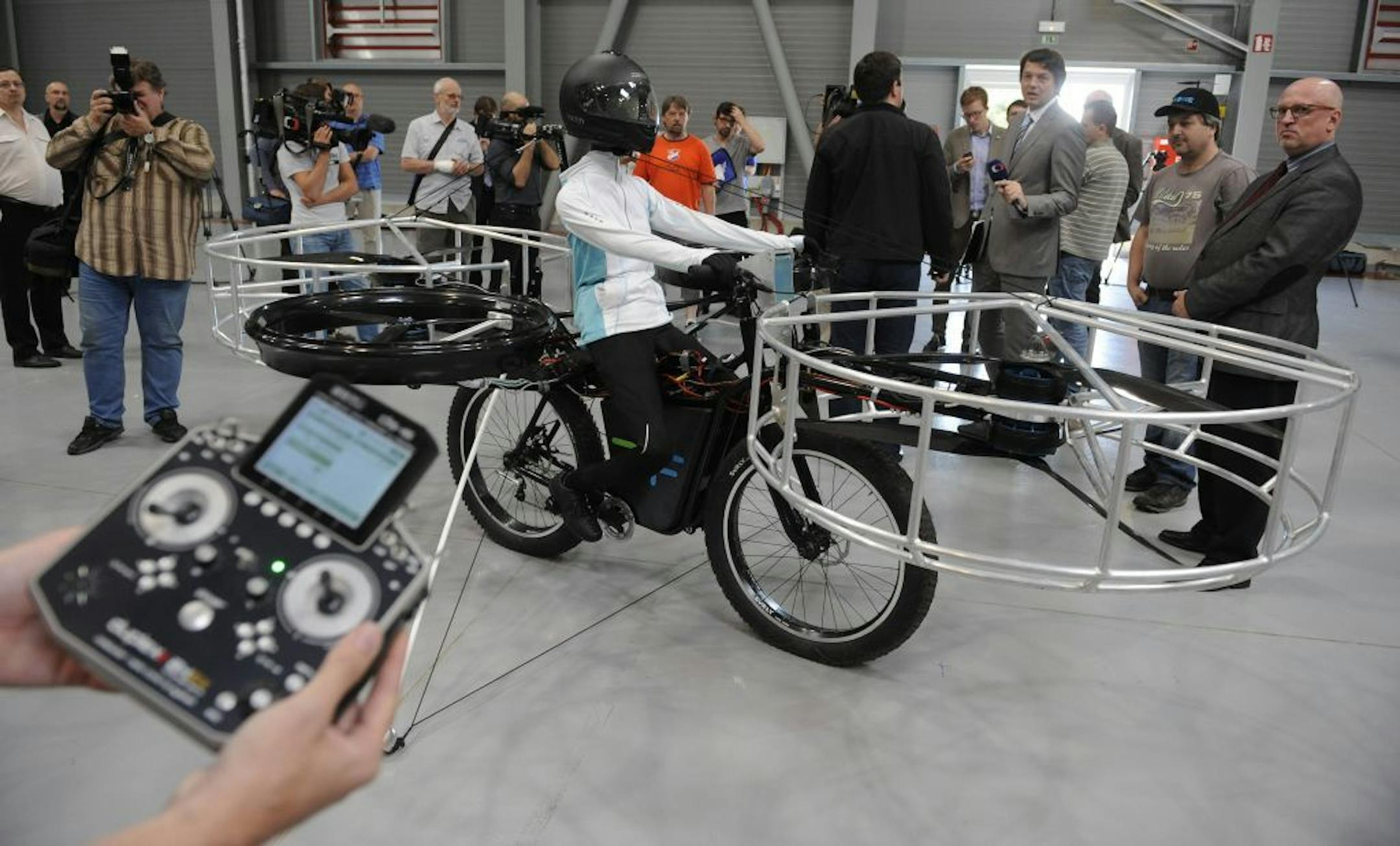 Journalists watch the remote-controlled Flying Bike with a test dummy during its presentation in Prague on Wednesday, June 12, 2013.