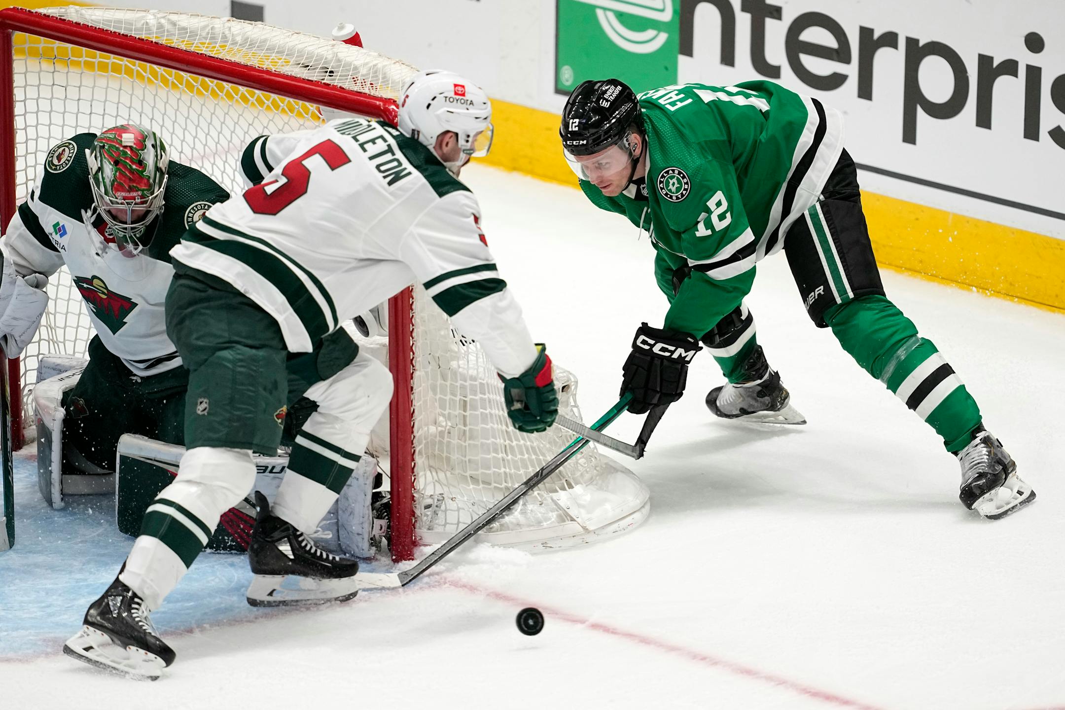 Dallas Stars center Radek Faksa (12) takes a shot from behind the net that was blocked by Minnesota Wild's Filip Gustavsson with help from Jake Middleton (5) in overtime of Game 1.