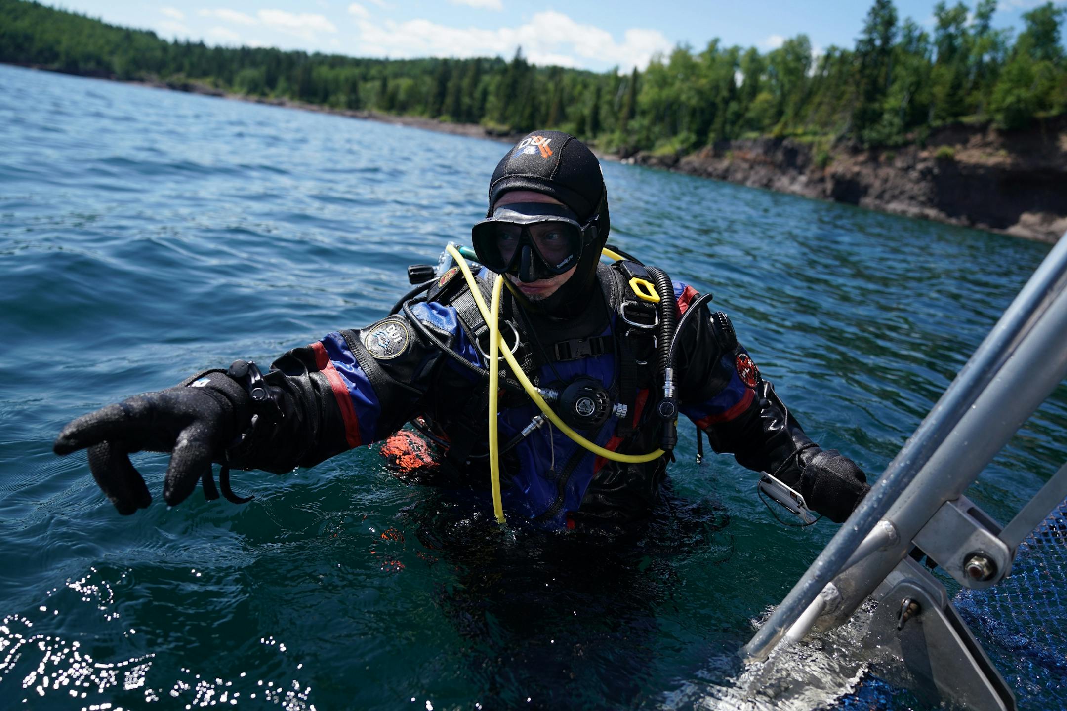 Jack Decker, a diver with the Great Lakes Shipwreck Preservation Society from Clear Lake, Iowa, pointed toward the underwater direction of the decent line below the mooring buoy on the Madeira.