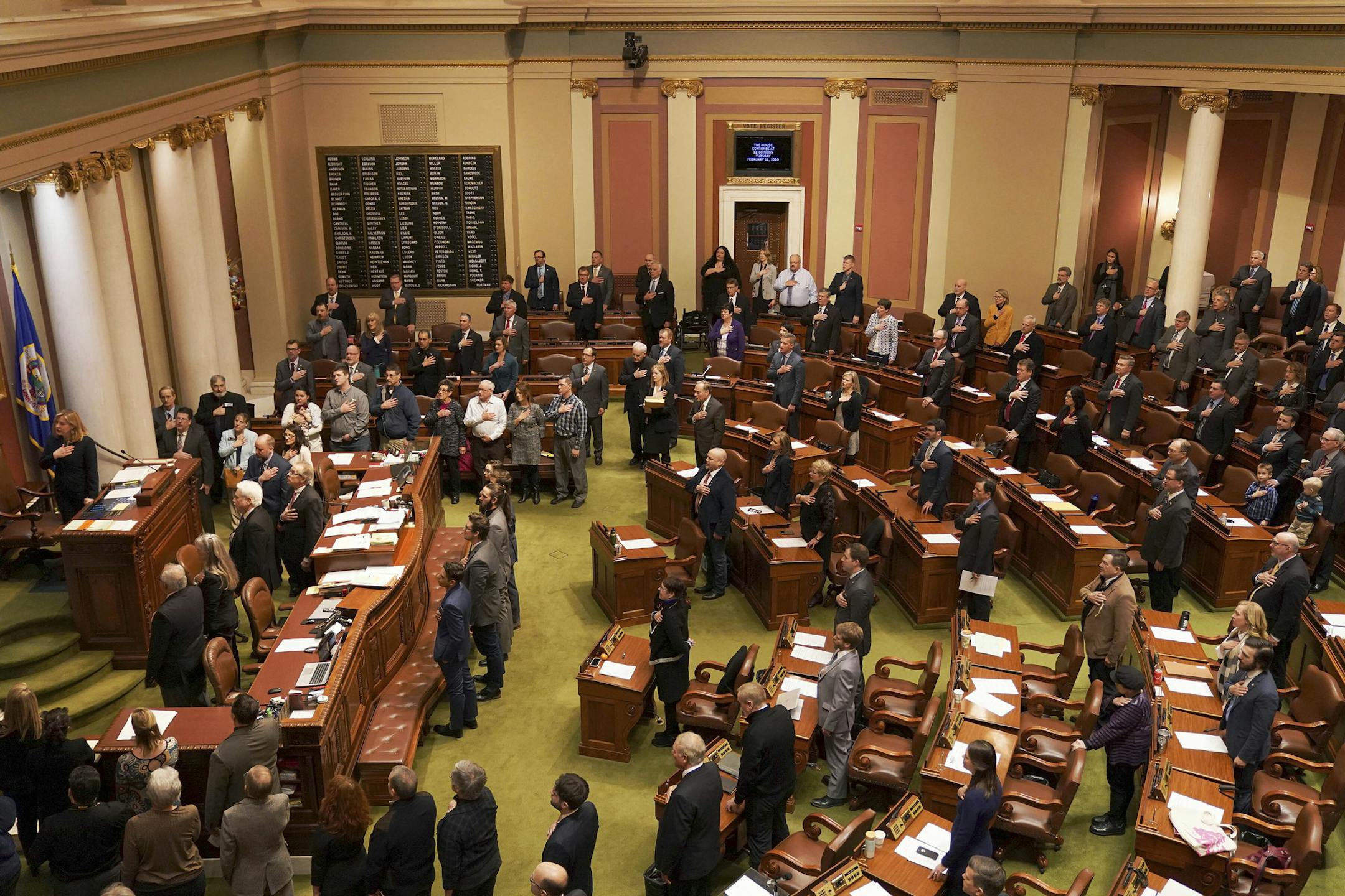 Minnesota State House representatives stood for the Pledge of Allegiance at the start of the legislative session Tuesday, Feb. 11, 2020 at the State Capitol in St. Paul, Minn. (Anthony Souffle/Star Tribune via AP)