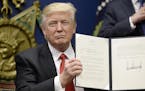 US President Donald Trump signs Executive Orders in the Hall of Heroes at the Department of Defense Friday, Jan. 27, 2017 in Arlington, Va. (Olivier D