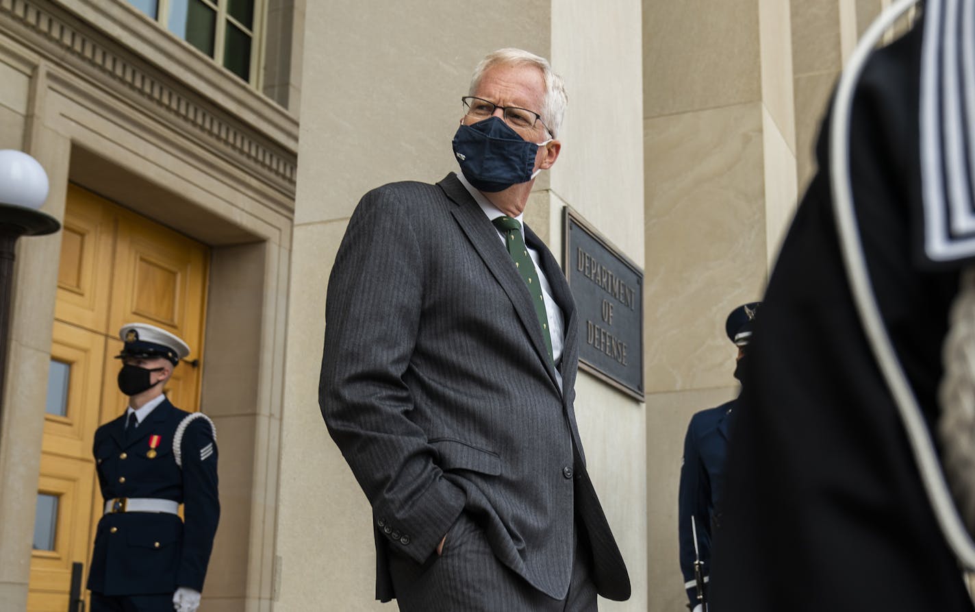 Acting Secretary of Defense Christopher Miller walks down the steps at the Pentagon during a November ceremony. The Pentagon said in a statement that Miller, on Monday, Nov. 30, accepted the resignation of Christopher Maier, who had provided policy oversight of the military's counter-IS effort since March 2017.