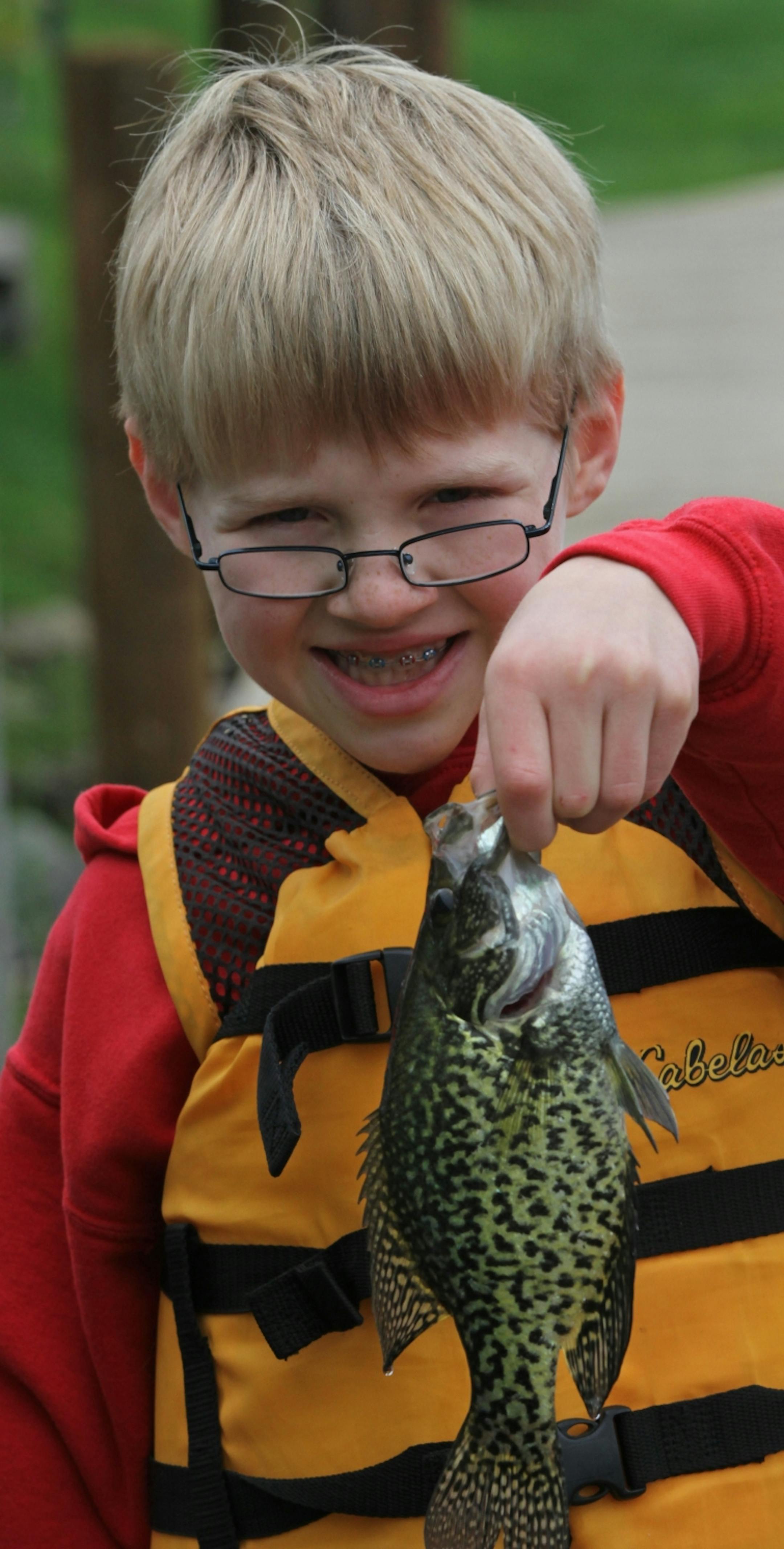 Aaron Petrie, age-10 from Plymouth, held up the fish he caught off the docks at Lord Fletchers, during the Minnesota Bound's Crappie Contest on Lake Minnetonka. Under sponsorship by Ron Schara's Minnesota Bound television show, the contest pre-registered over 1000 anglers for the event based out of Lord Fletcher's on Lake Minnetonka, 5/5/12.