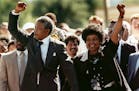 FILE - In this Feb. 11, 1990 file photo, Nelson Mandela, left, and his wife Winnie, raise clenched fists as they walk hand-in-hand from the Victor Ver