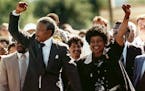 FILE - In this Feb. 11, 1990 file photo, Nelson Mandela, left, and his wife Winnie, raise clenched fists as they walk hand-in-hand from the Victor Ver