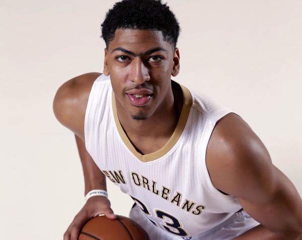 New Orleans Pelicans forward Anthony Davis (23) poses at the Pelicans NBA basketball media day in Metairie, La., Monday, Sept. 29, 2014. (AP Photo/Ger